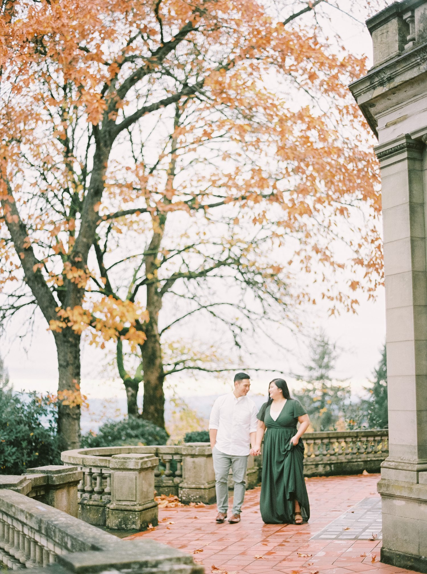 Engaged couple walking at Pittock Mansion 