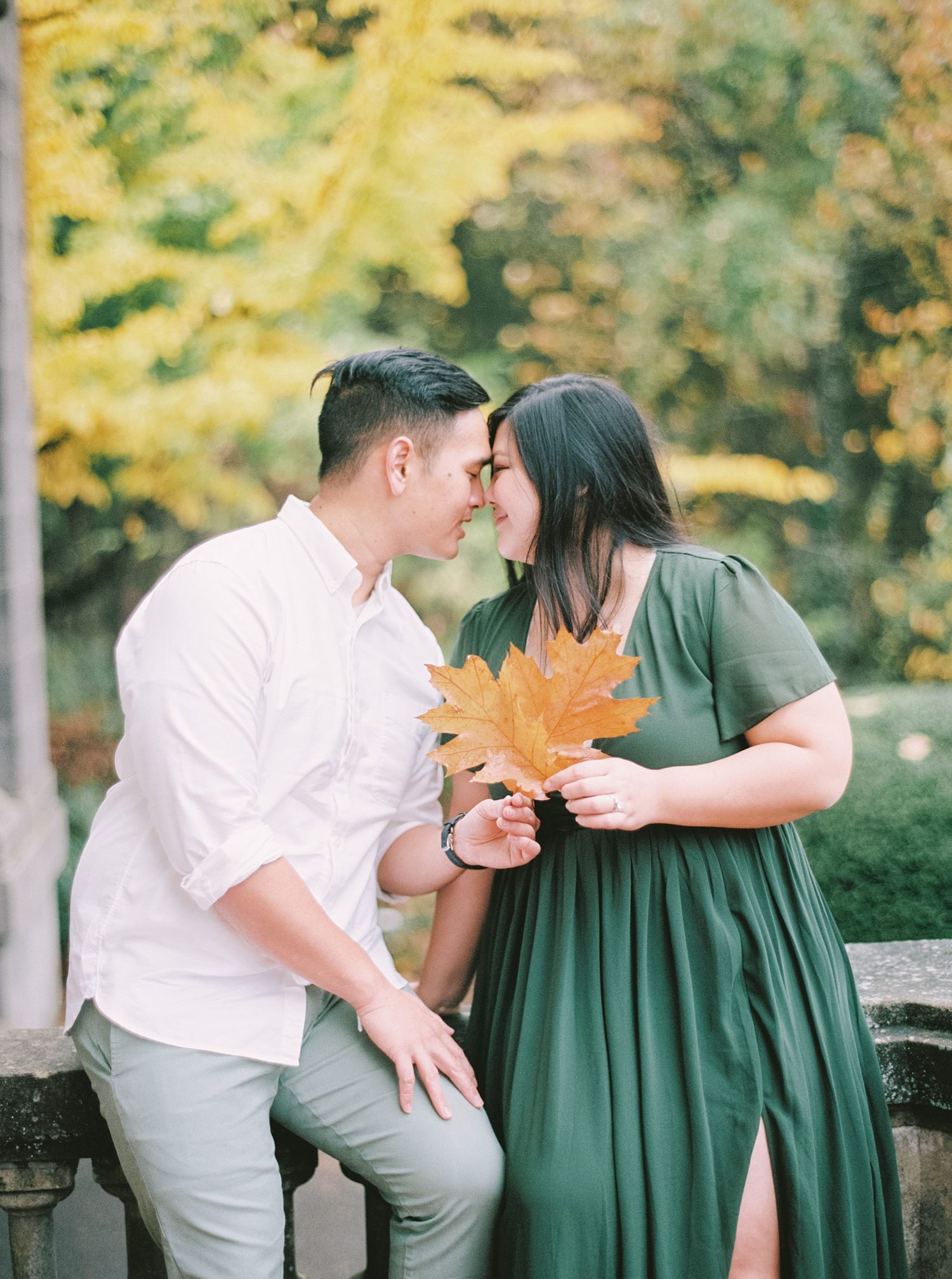 bride and groom holding giant leaf