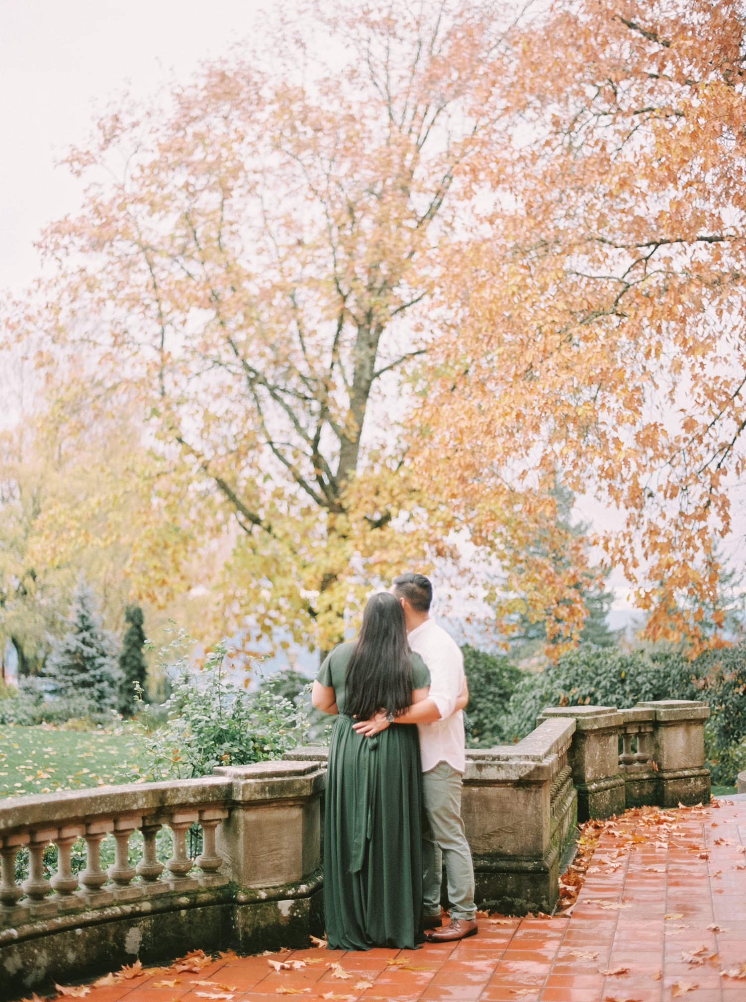 autumn colors surrounding an engaged couple