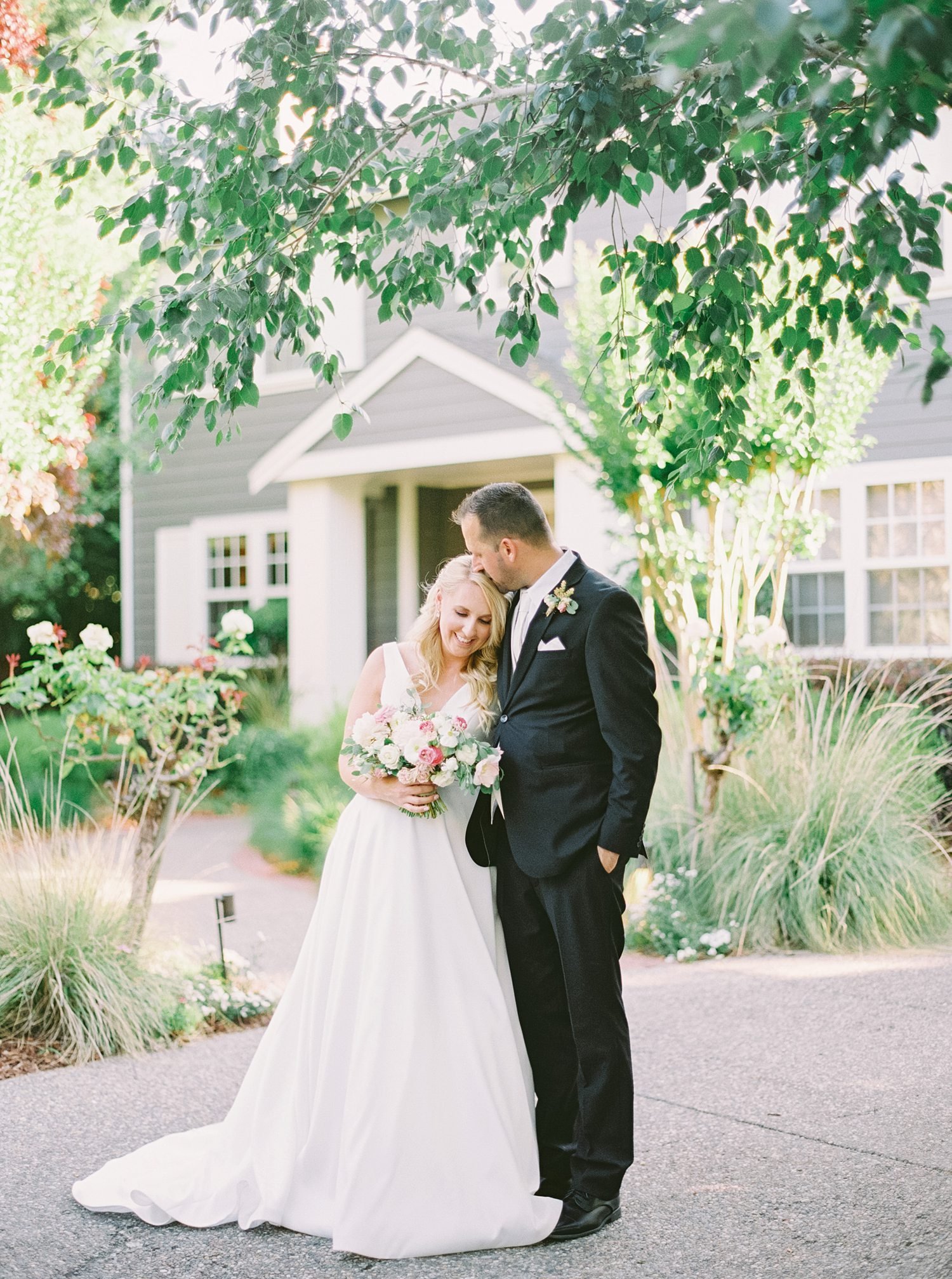 Bride and Groom in front of backyard wedding house