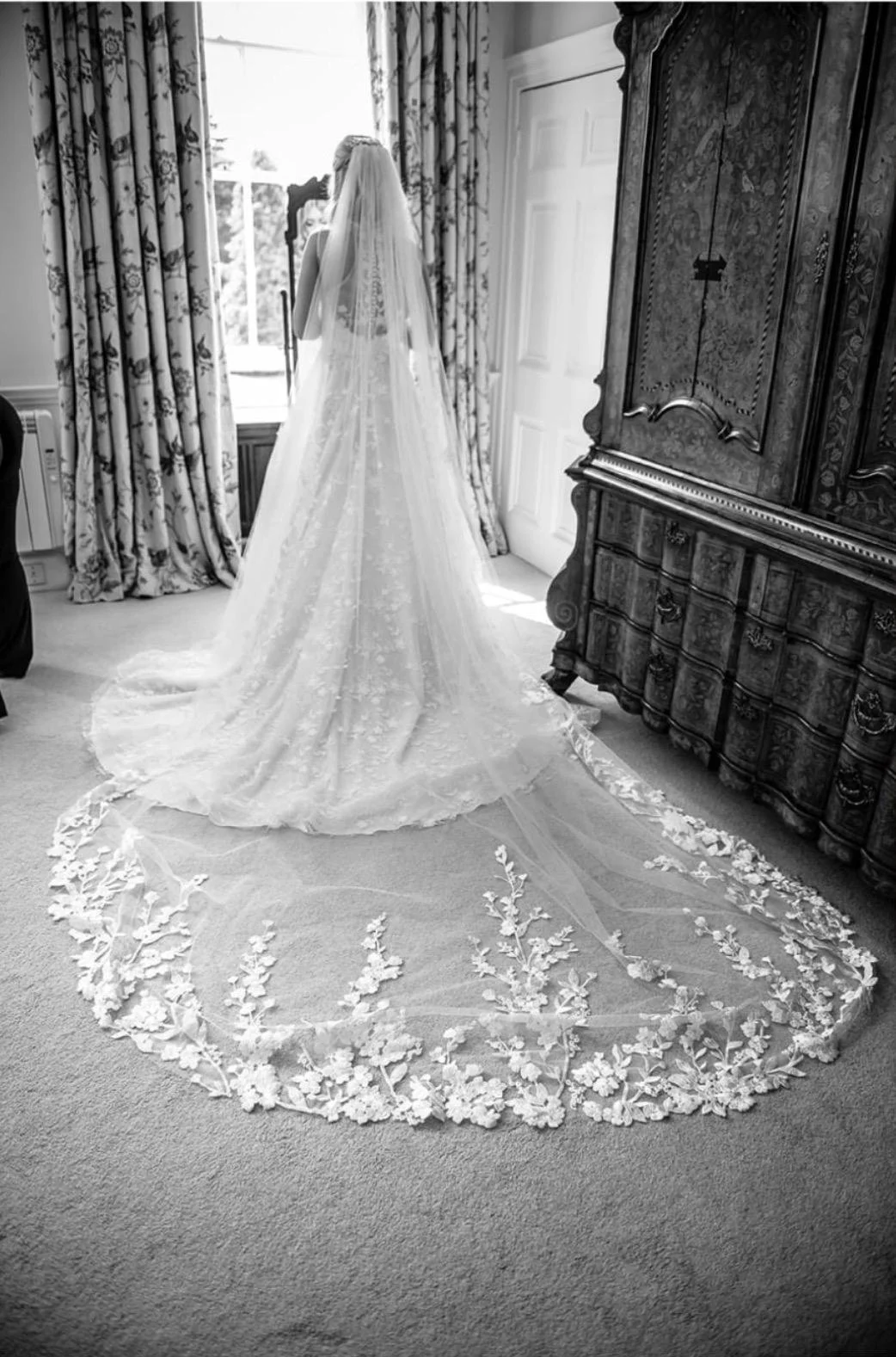 Real bride Jade showing the back, train and veil of her wedding dress from Cristello Bridal