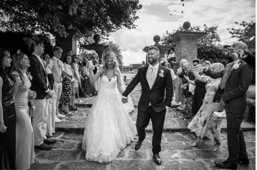 Real bride Jade walking with her husband on their wedding day