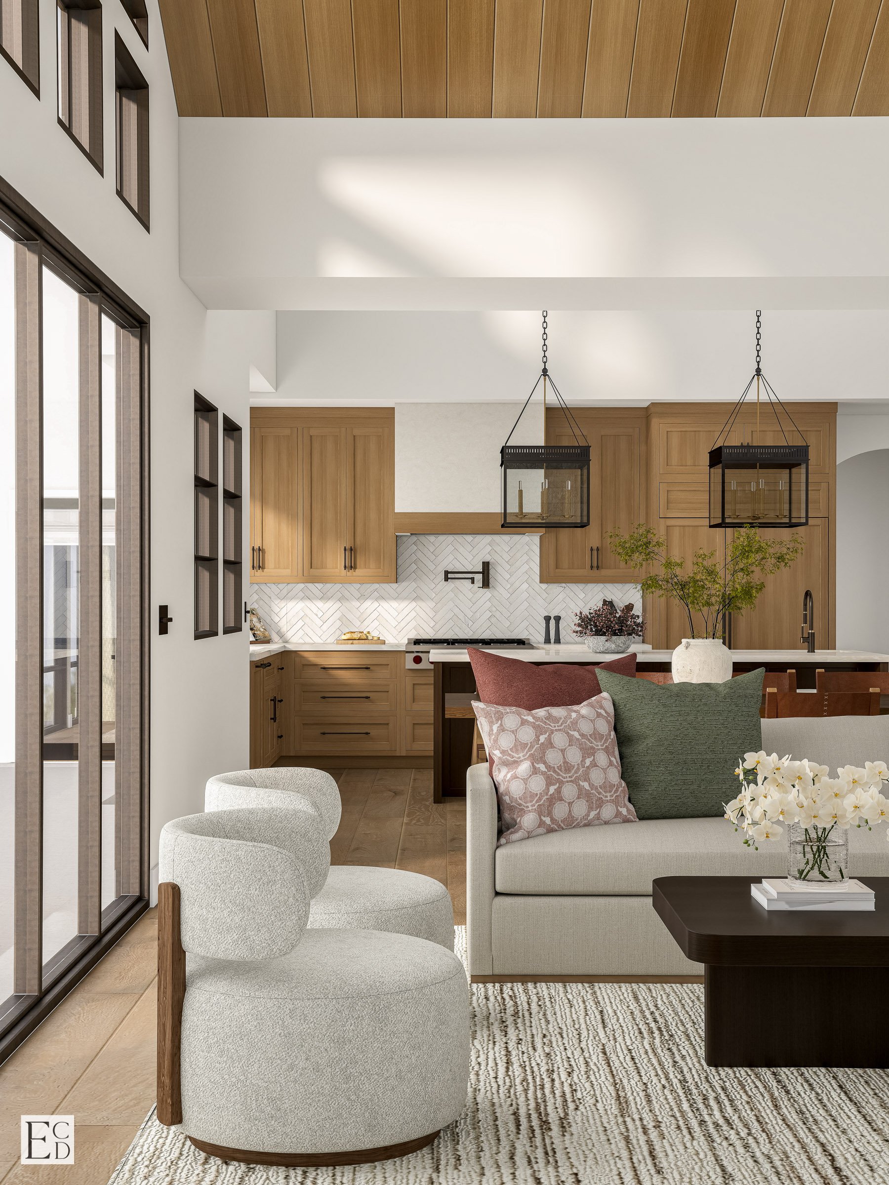 From the seating area, bouclé swivels and a low dark coffee table sit against the white oak kitchen beyond.