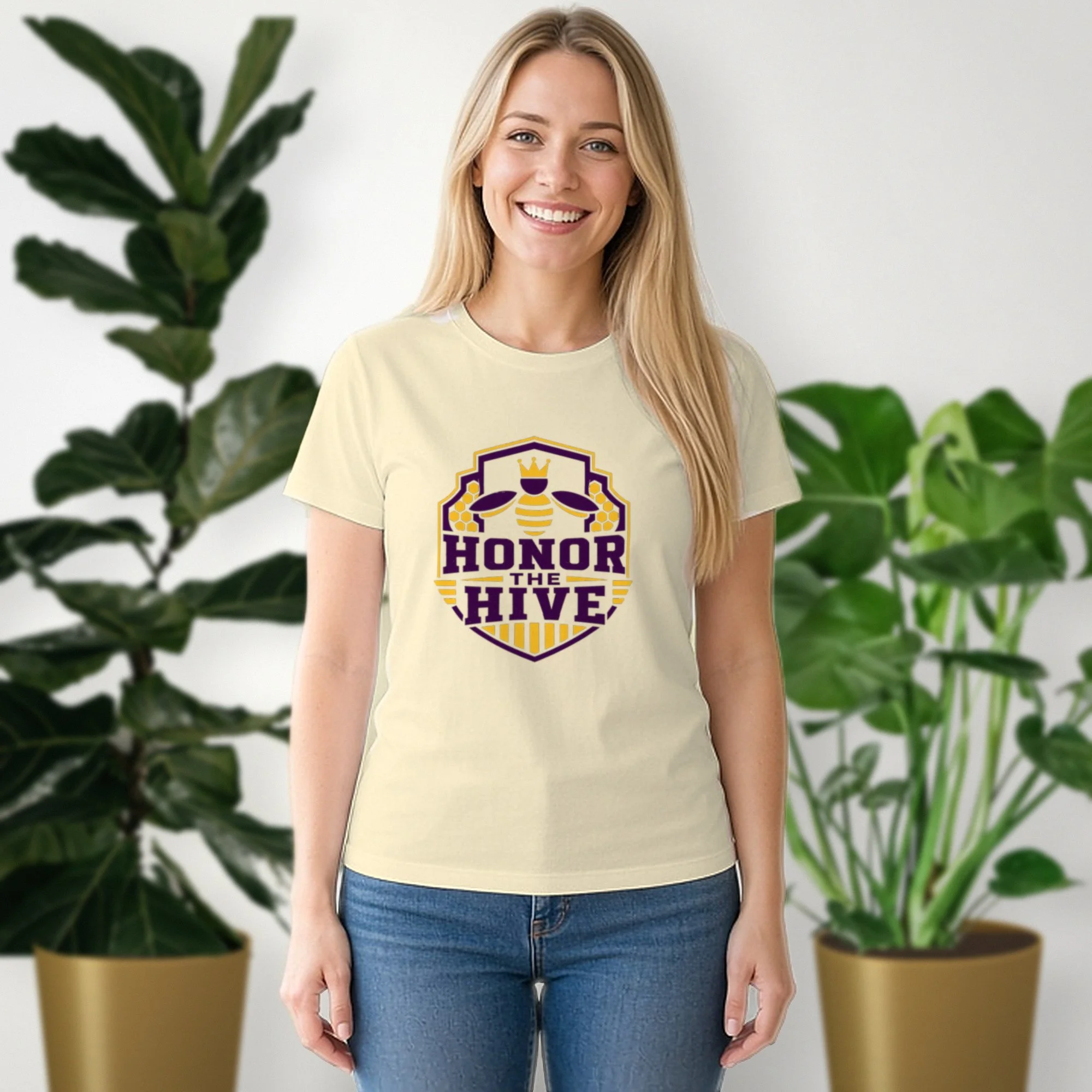 Honor the Hive tee in natural, worn by a model in front of potted plants