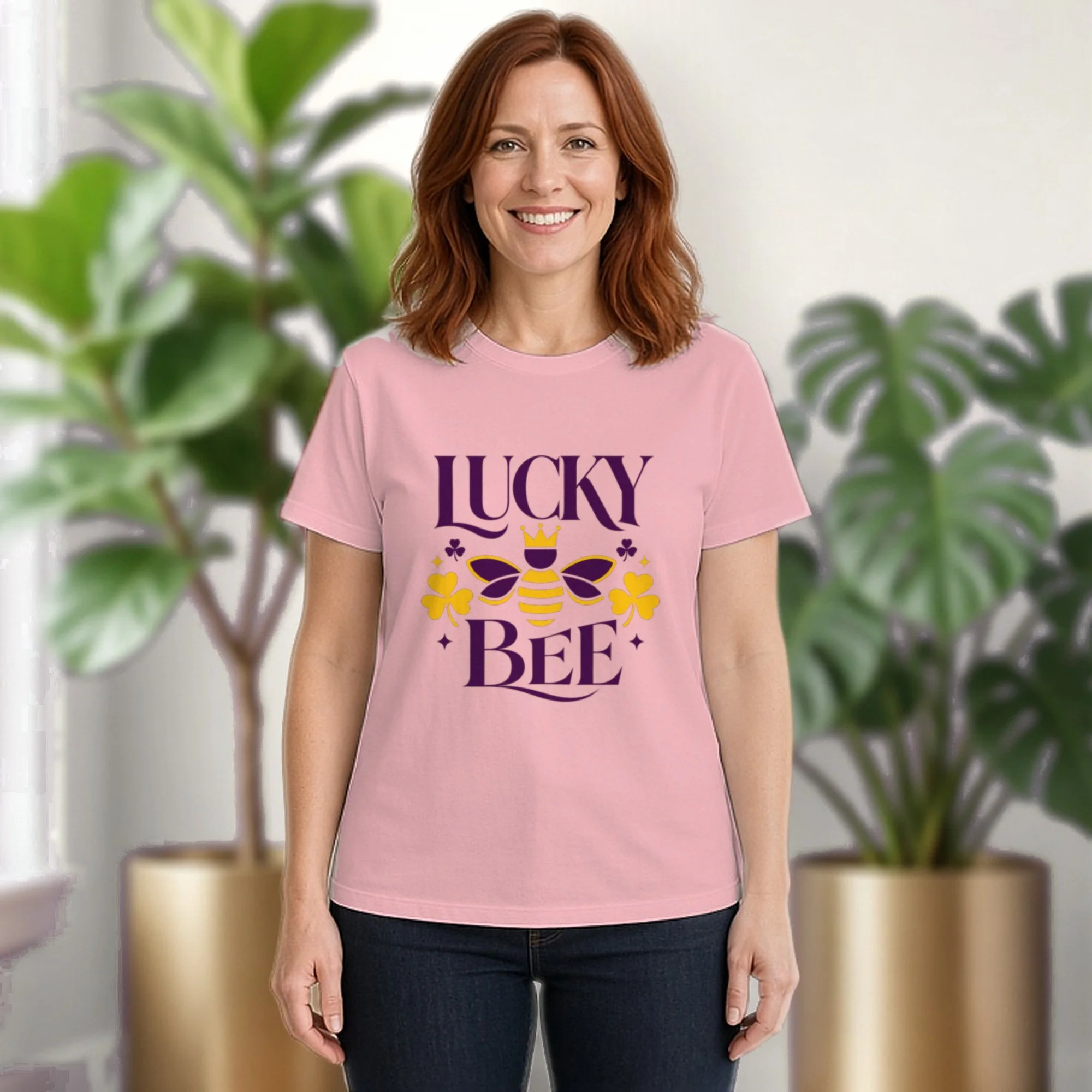 Lucky Bee tee in pink, worn by a model in front of potted plants