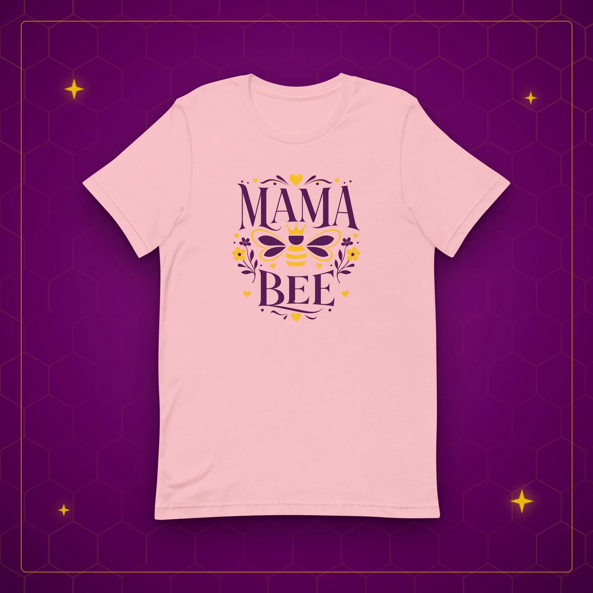 Mama Bee tee in pink, laid flat on a purple background with gold sparkles