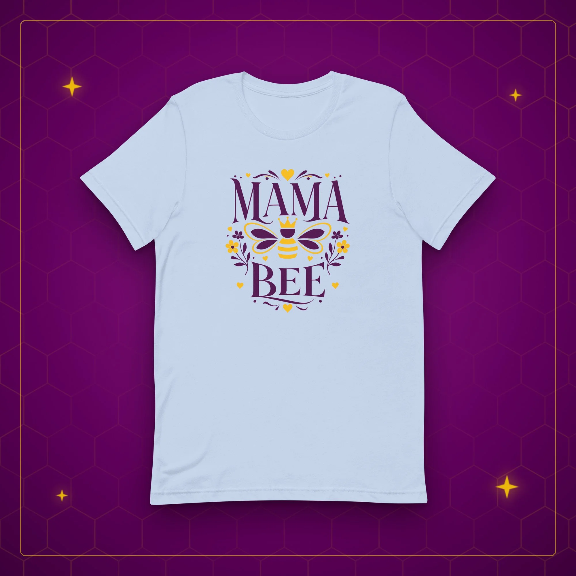 Mama Bee tee in baby blue, laid flat on a purple background with gold sparkles