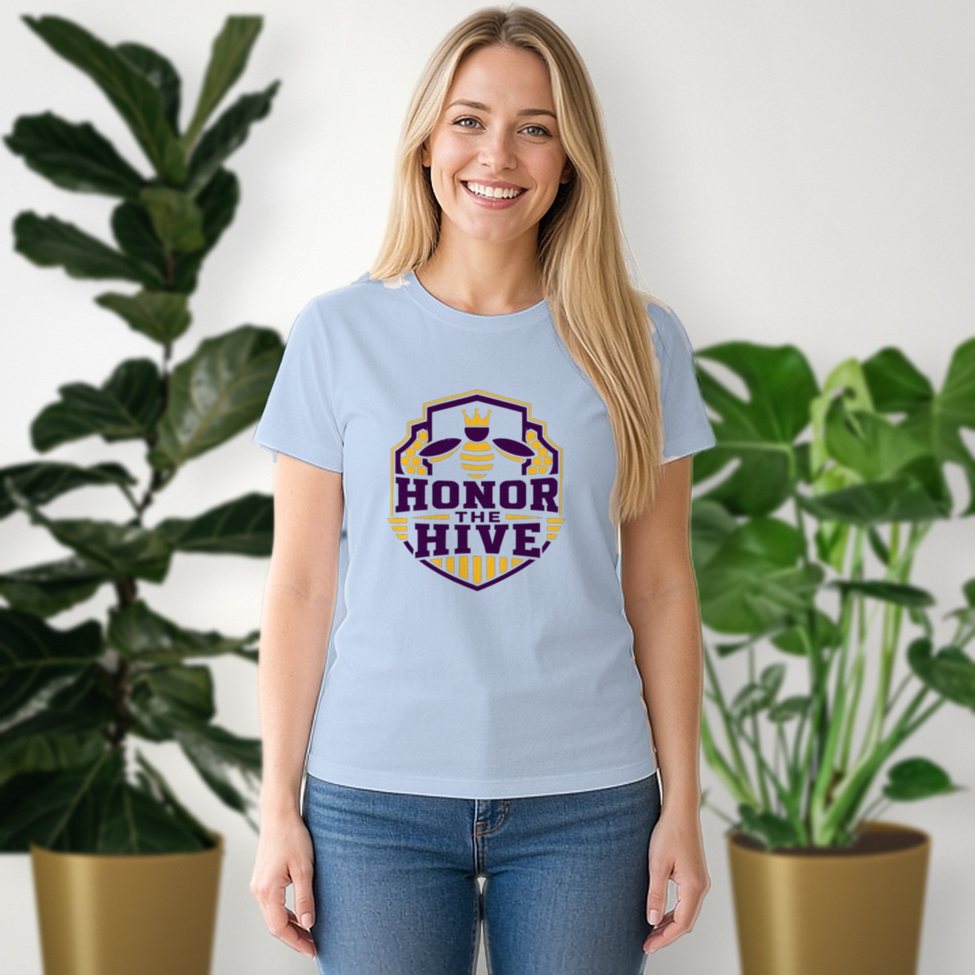 Honor the Hive tee in baby blue, worn by a model in front of potted plants