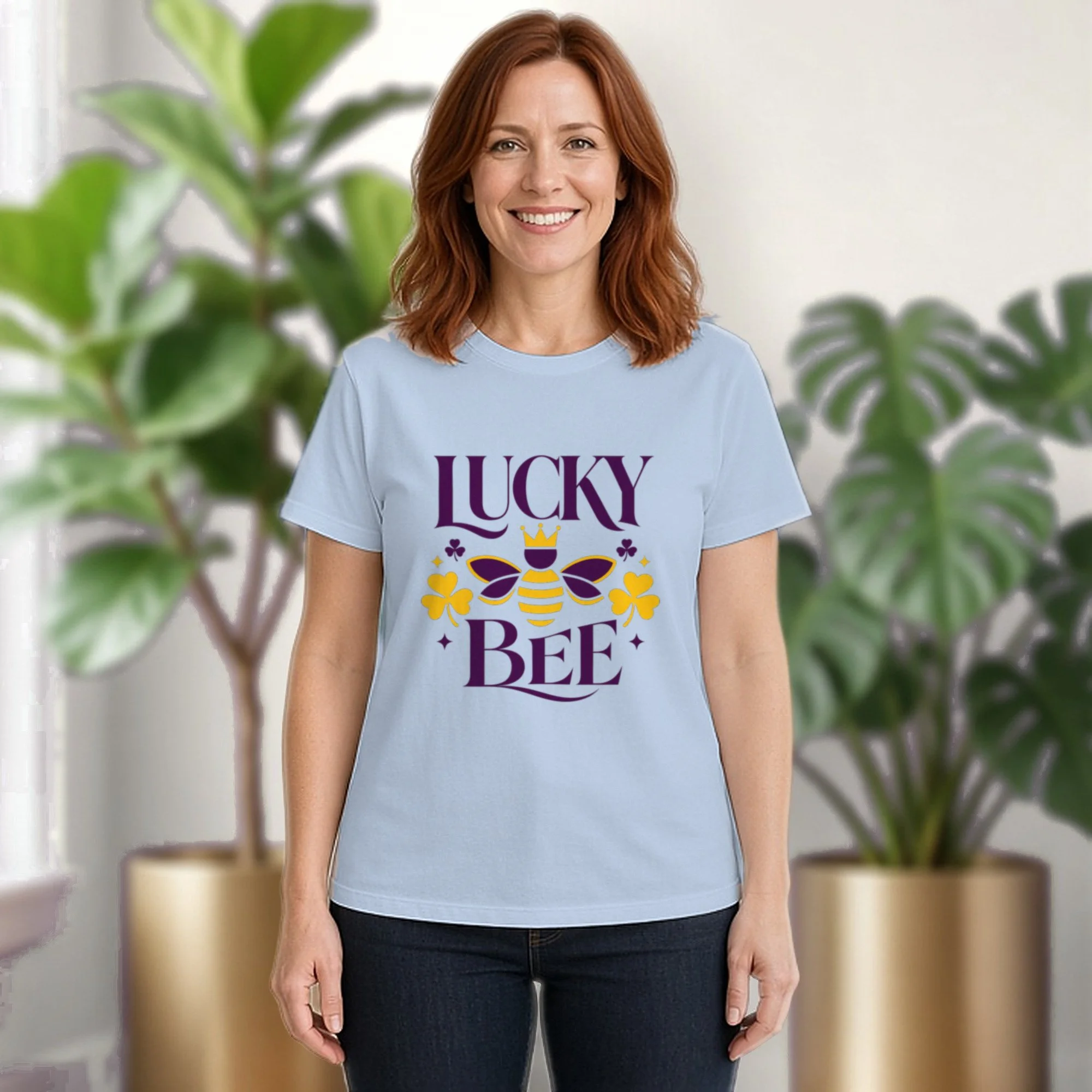 Lucky Bee tee in baby blue, worn by a model in front of potted plants