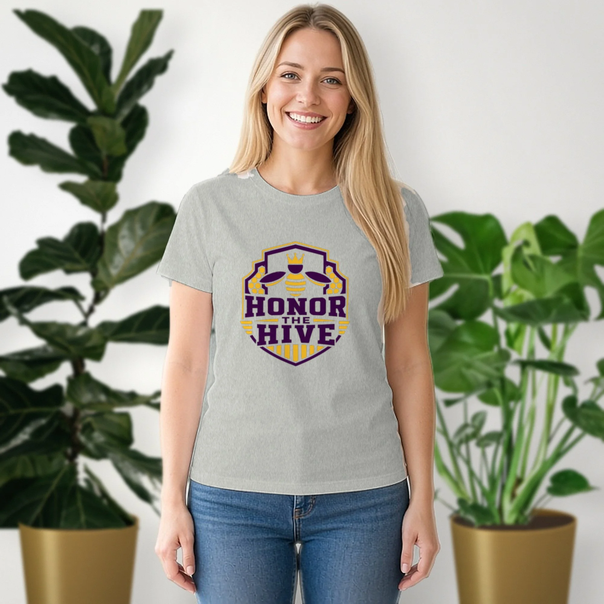 Honor the Hive tee in athletic heather, worn by a model in front of potted plants