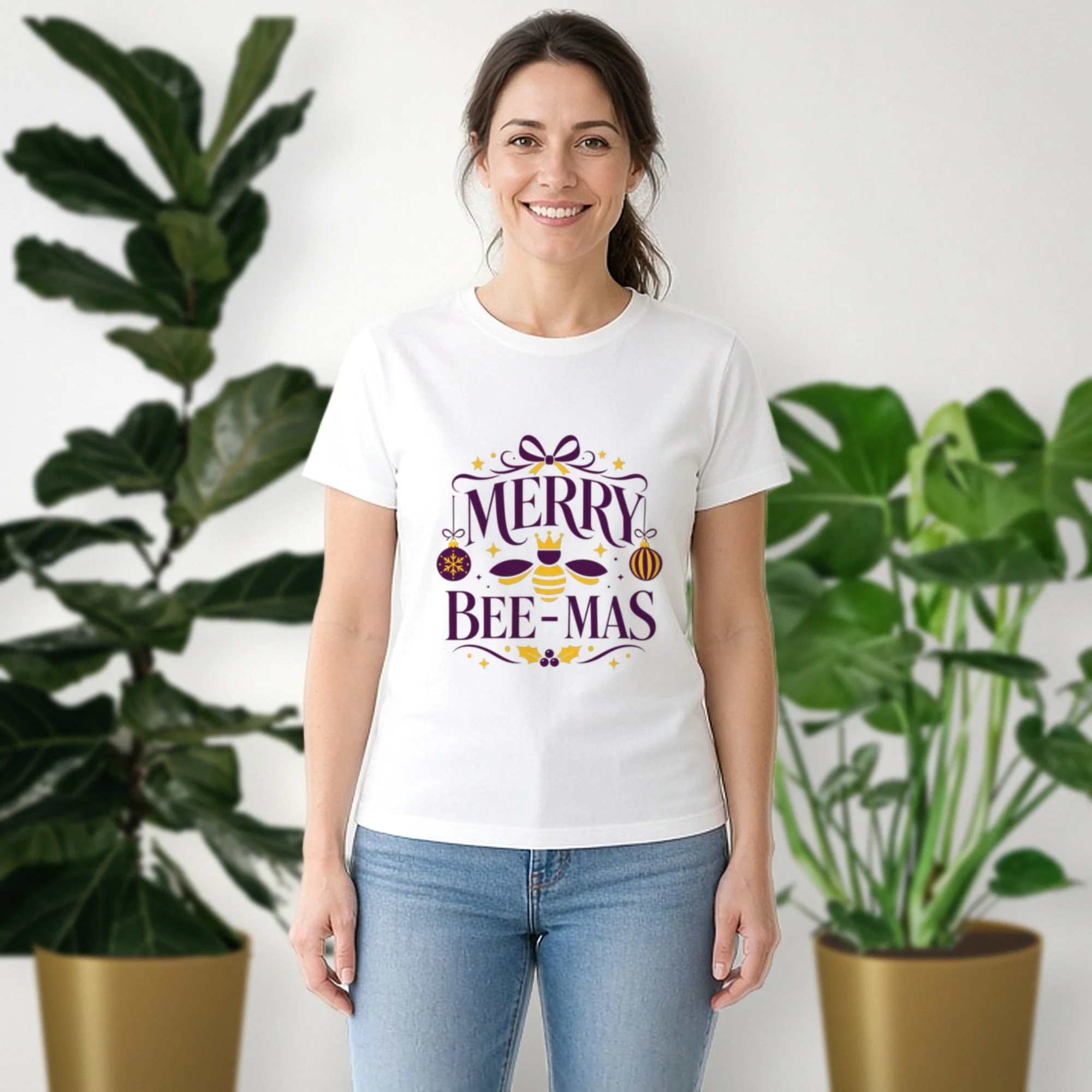 Merry Bee-mas tee in white, worn by a model in front of potted plants