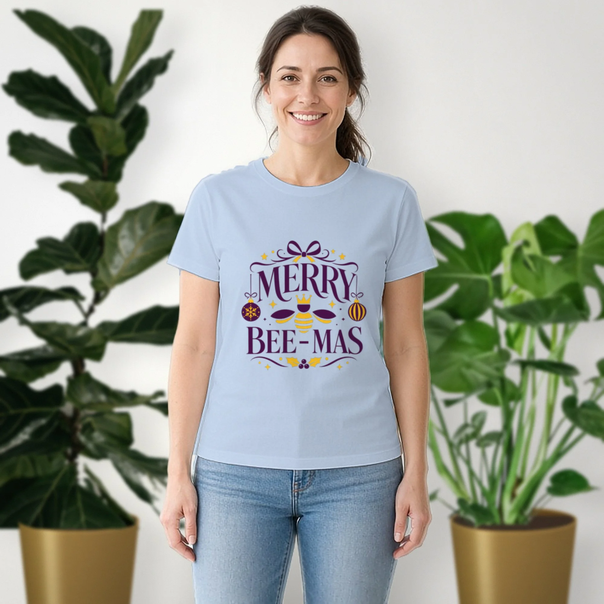Merry Bee-mas tee in baby blue, worn by a model in front of potted plants