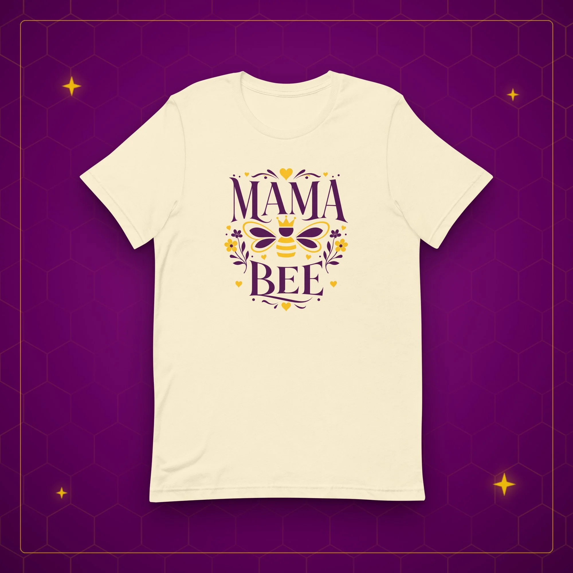 Mama Bee tee in natural, laid flat on a purple background with gold sparkles