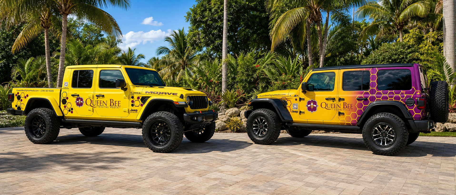 Two yellow Jeep vehicles parked on a paved surface with palm trees and lush greenery in the background. The vehicles have decals for Queen Bee Digital Media, with purple and black honeycomb and bee graphics, and text indicating their promotional branding.