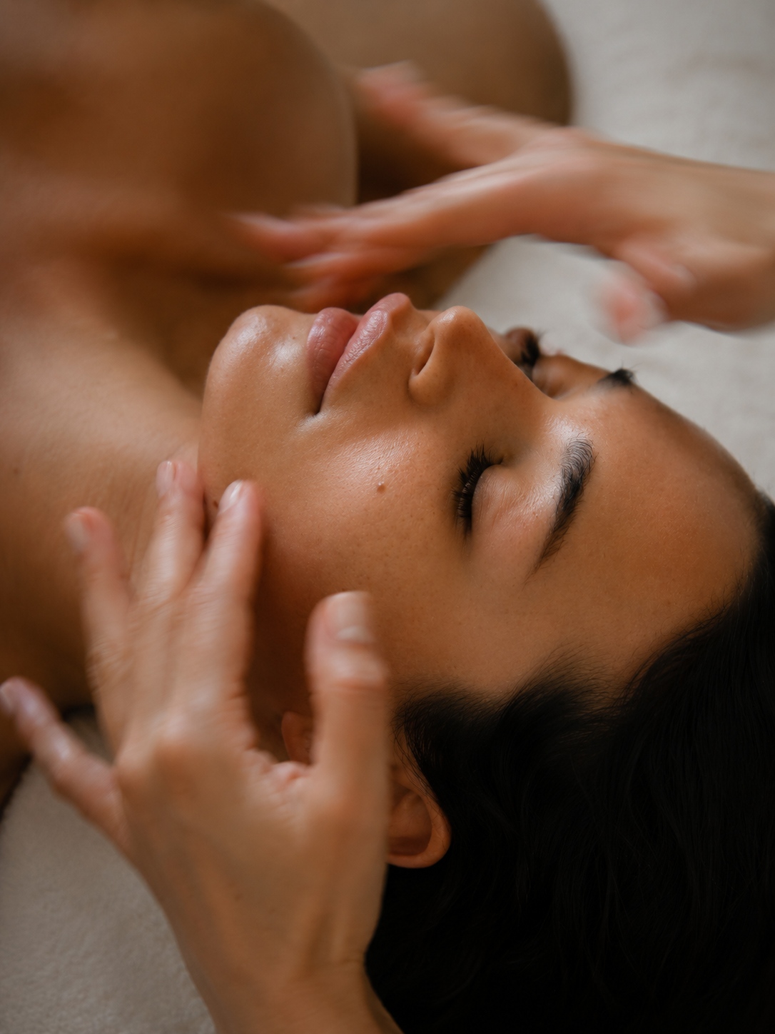 Aesthetician performing a calming facial massage