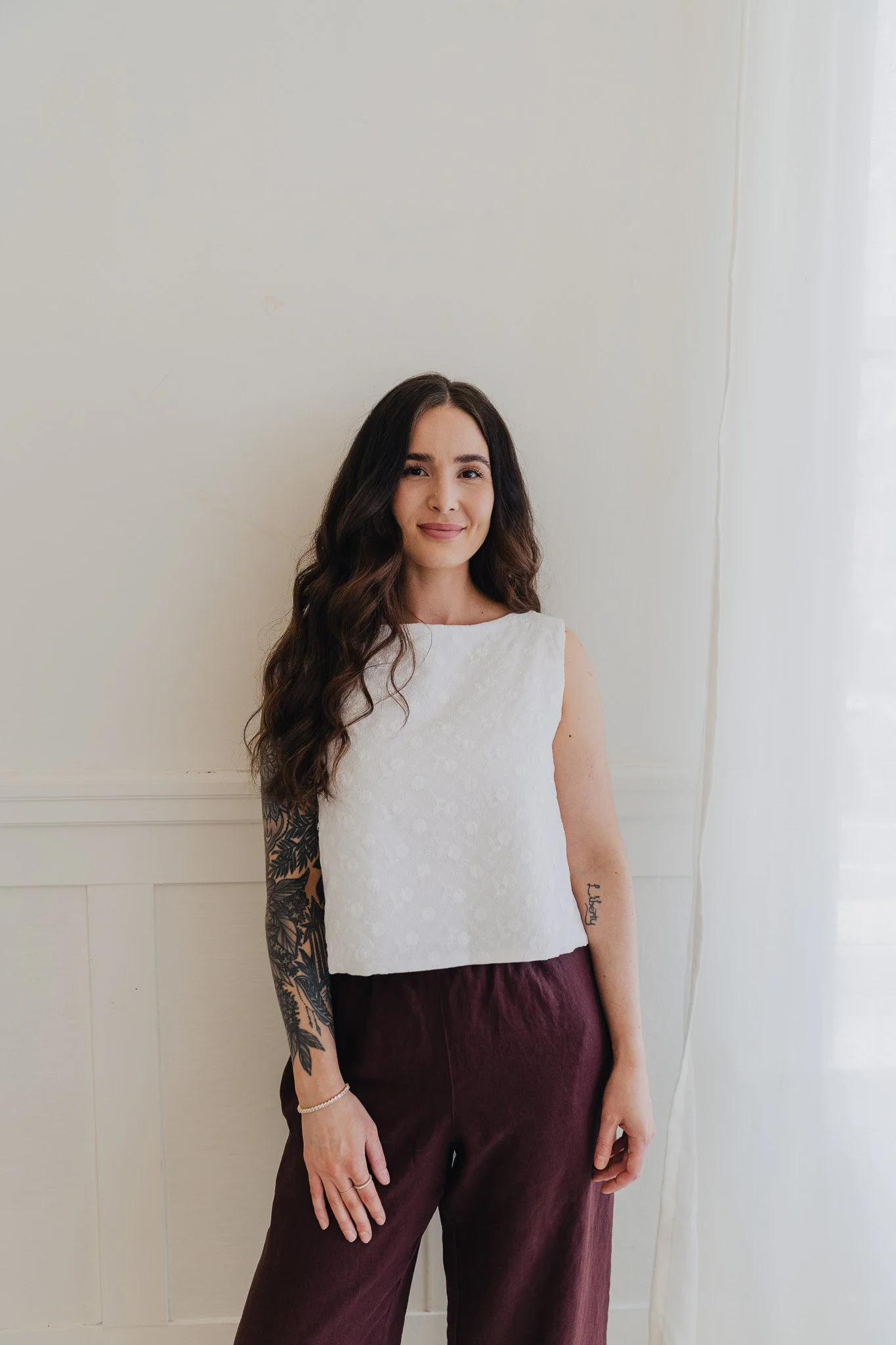 Portrait of Jordan Radke, founder and educator at JRAD SKIN, standing beside soft natural light in the clinic