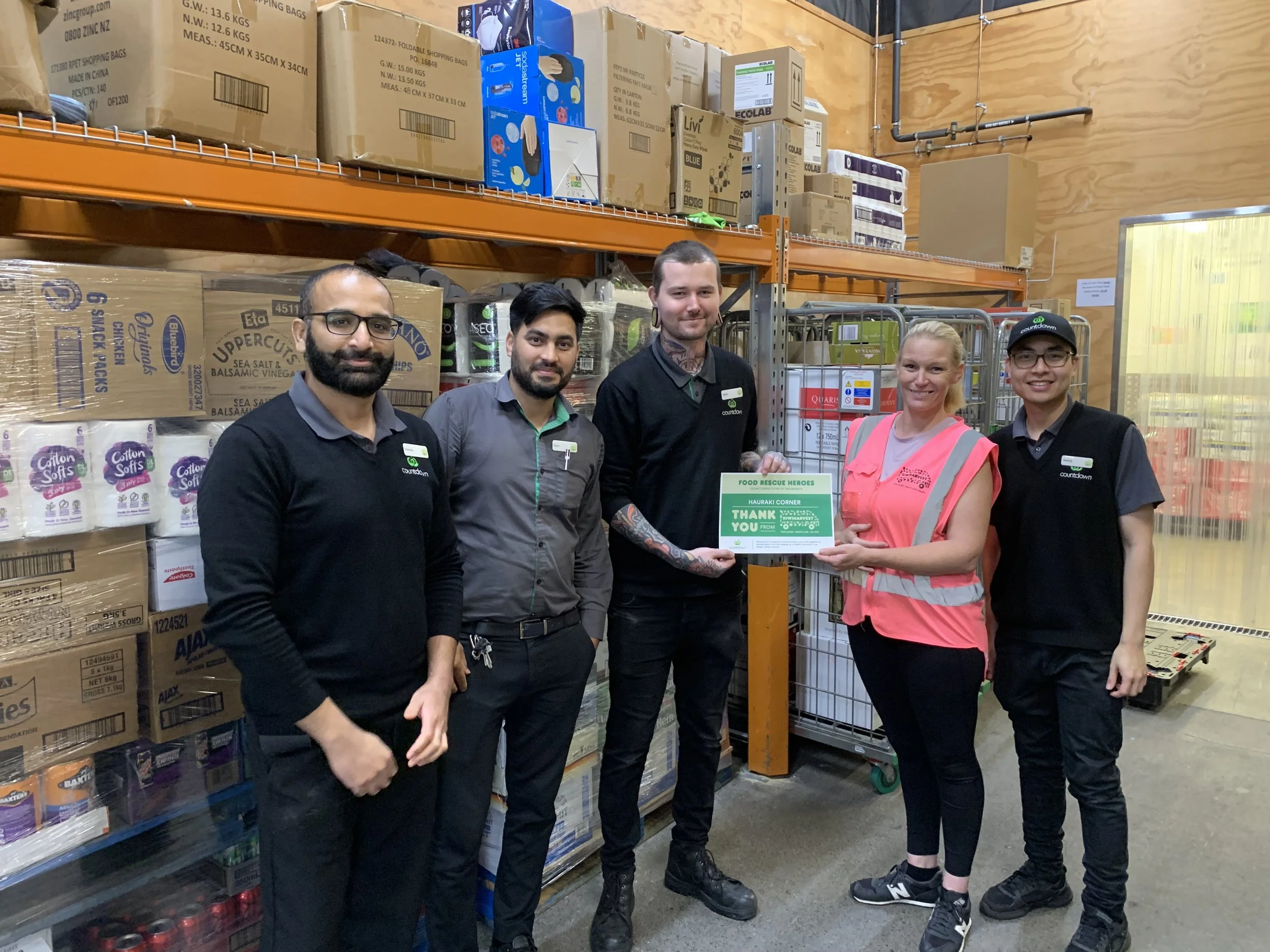 North Shore Woolworths store manager receiving a store of the month award from KiwiHarvest food rescue driver