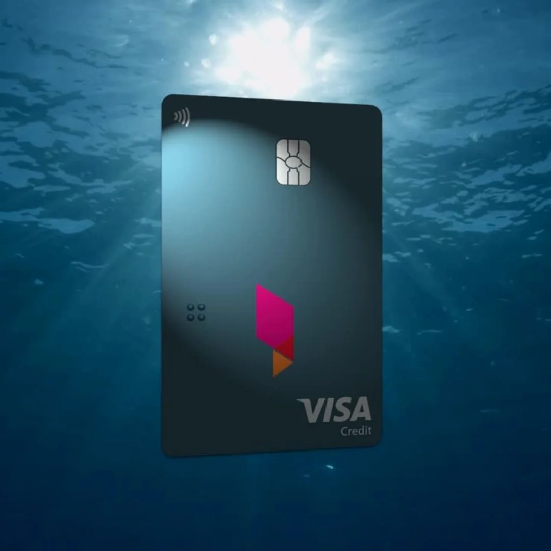 VISA credit card underwater with sunlight filtering through water.