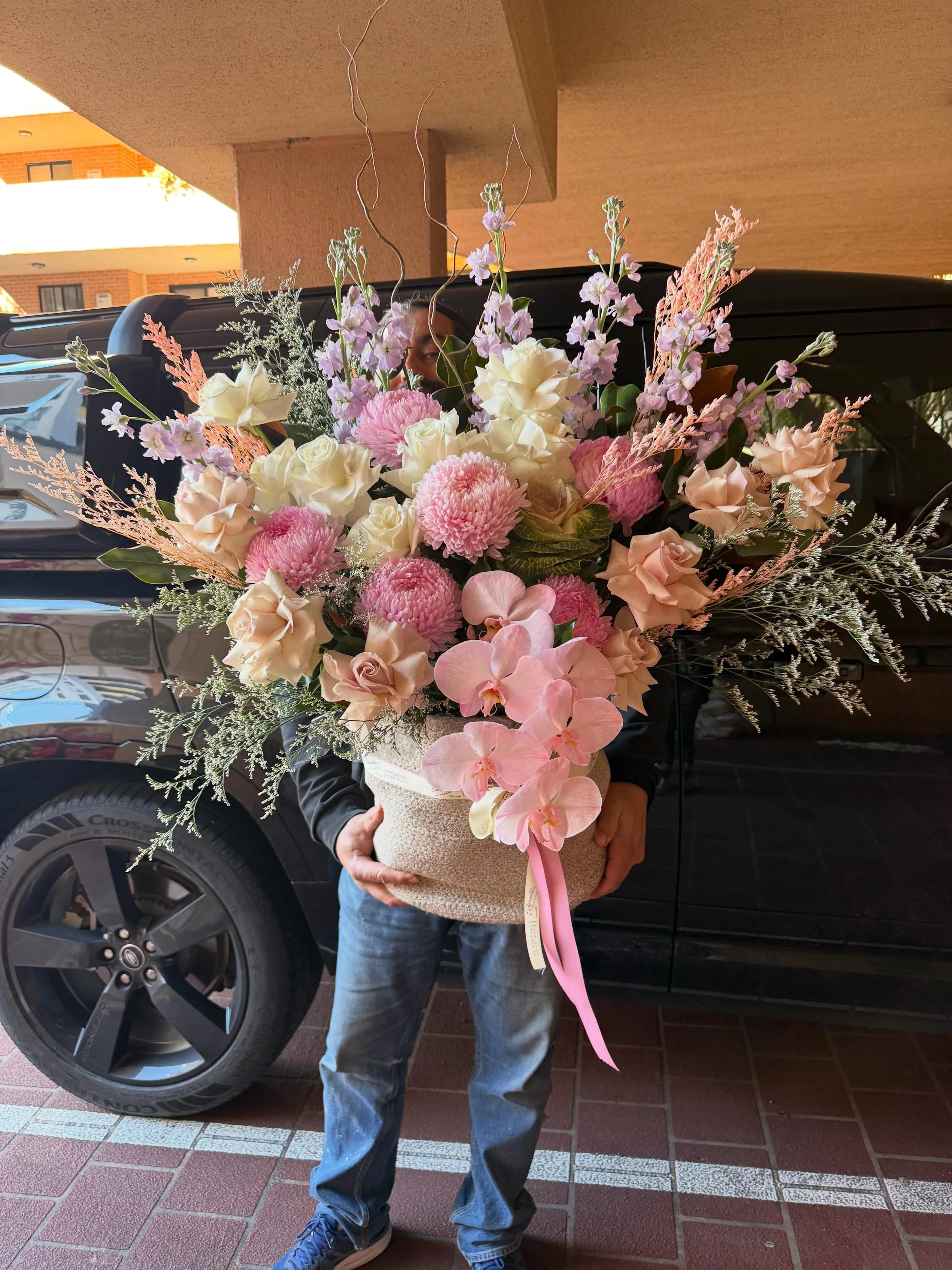 A breathtaking basket overflowing with fresh seasonal blooms, thoughtfully arranged to create a luxurious and unforgettable display. Designed with elegance and care, this stunning floral creation brings beauty, colour, and joy to any celebration, hea
