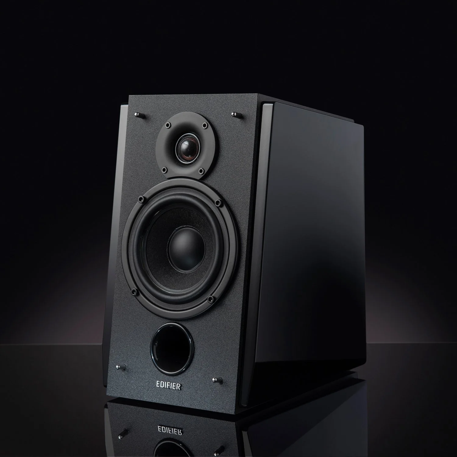hero product photography showing a single edifier shelf speaker with a graduated black background