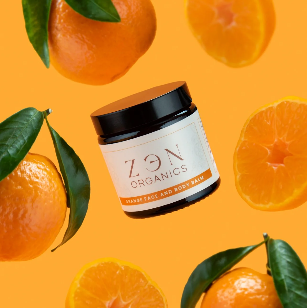 hero  product photography showing zen organics cosmetics skincare with oranges on an orange background