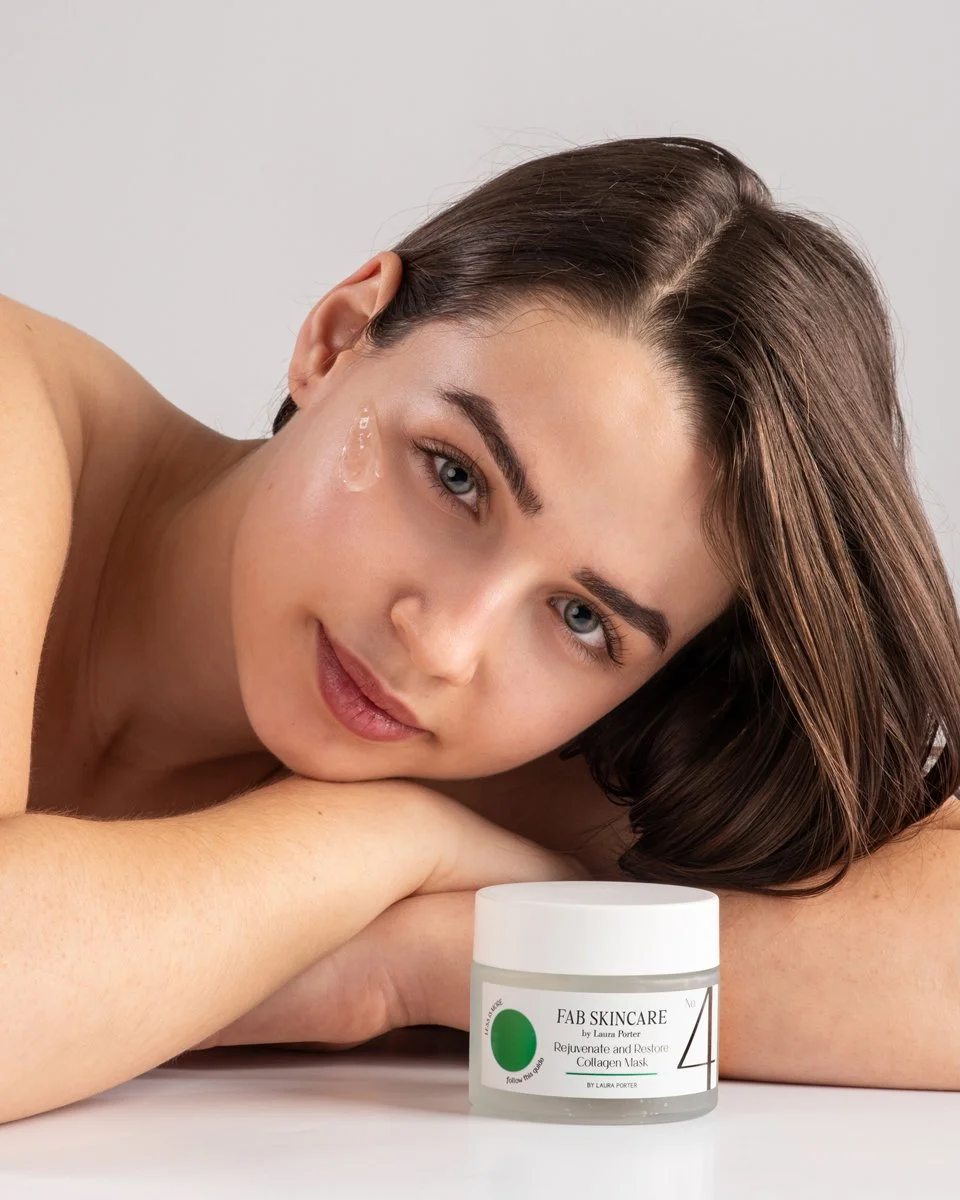 lifestyle product photography shot for FAB face and body skincare product with young dark haired model with swatch of product on face  