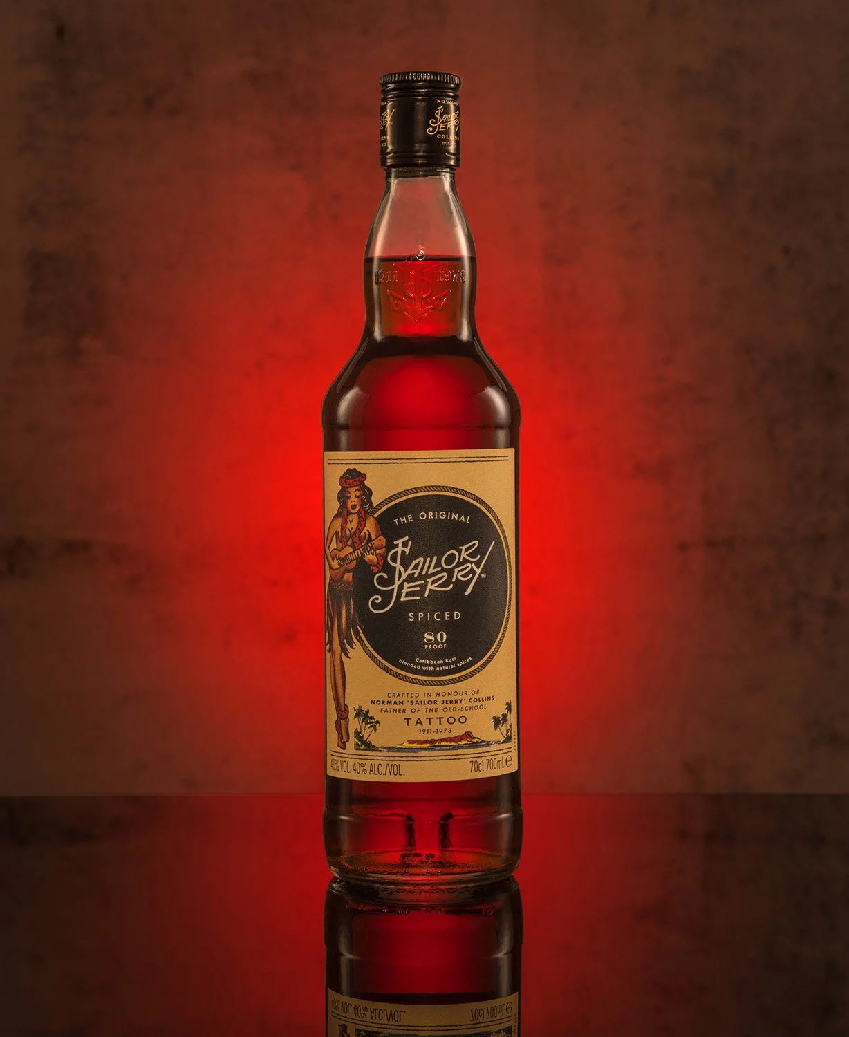hero product photography showing a bottle of sailor jerry rum on a textured red background with graduated light