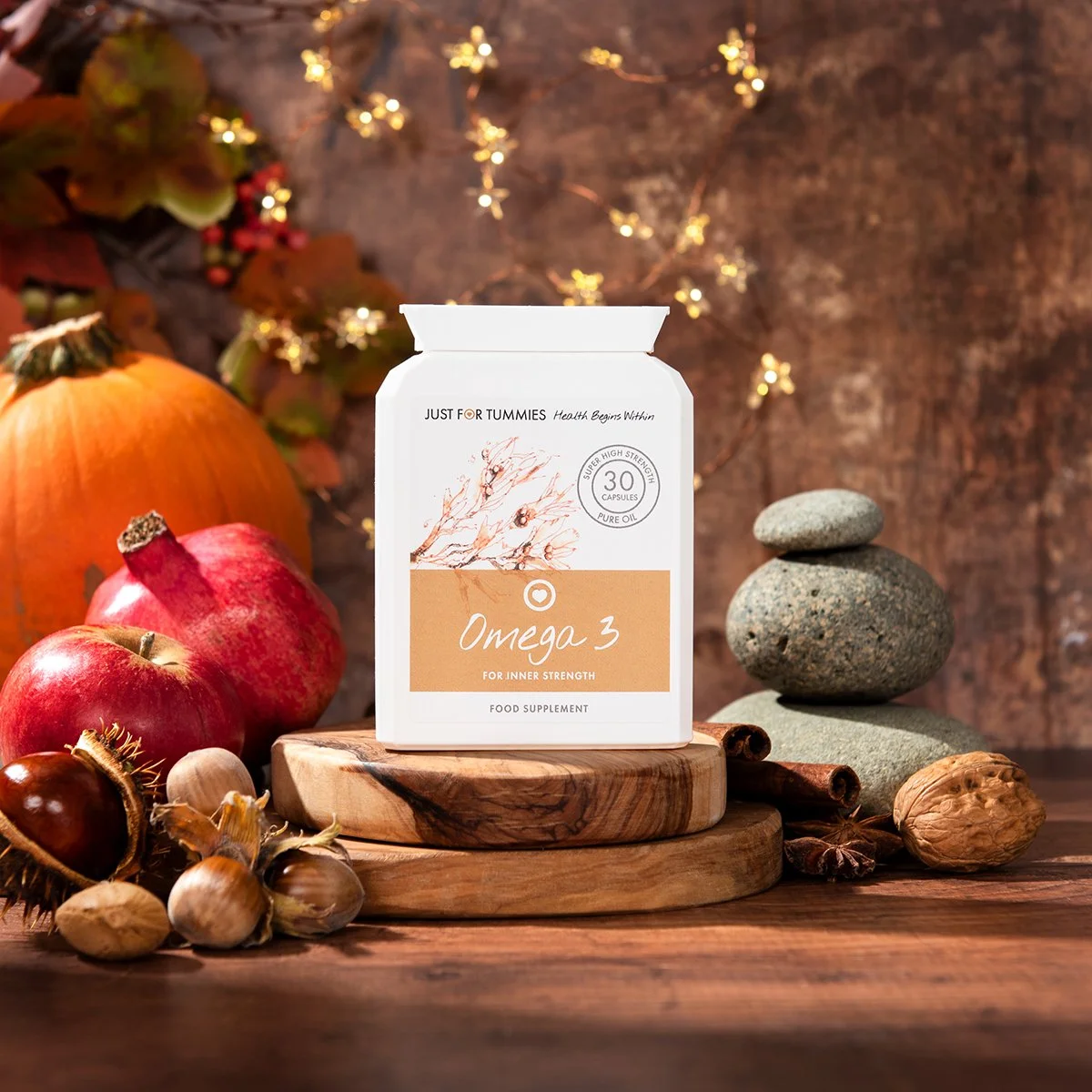 health care Omega 3 supplements vitamins on textured brown background with autumnal props product photography from roy mccready