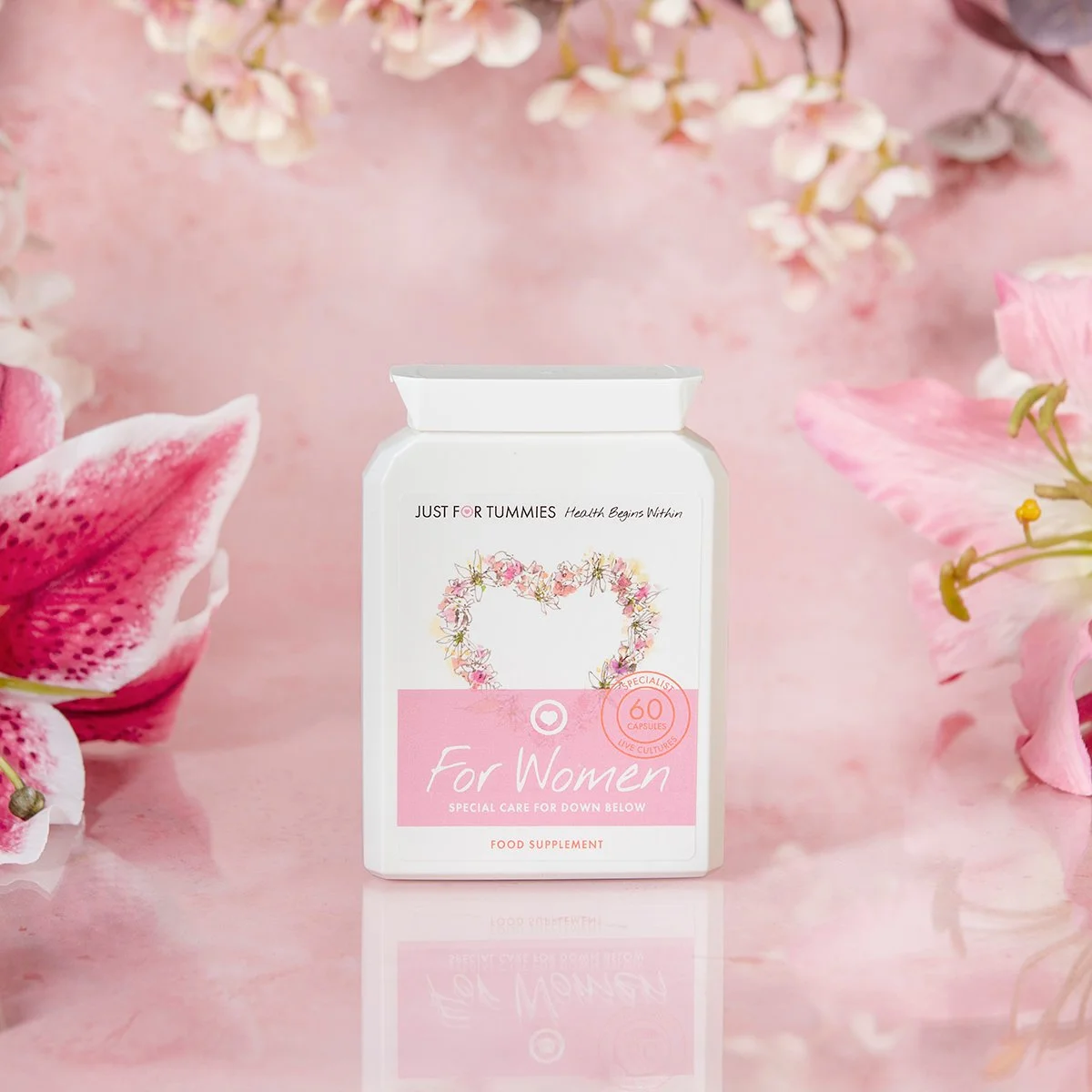 health care supplements for women on pink background with flowers product photography from roy mccready