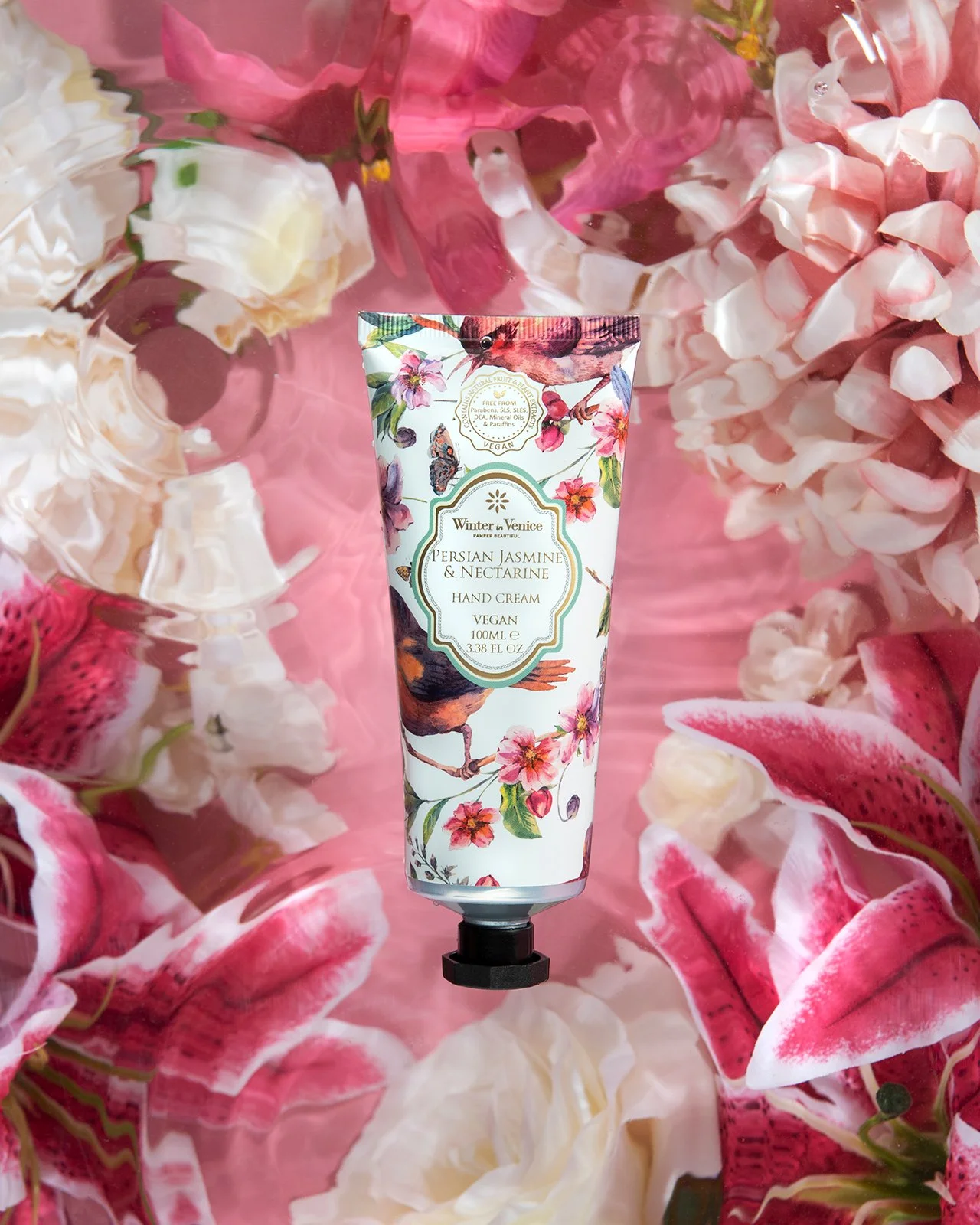 hero product photography showing hand cream tube cosmetics skincare beauty on floral background with ripples