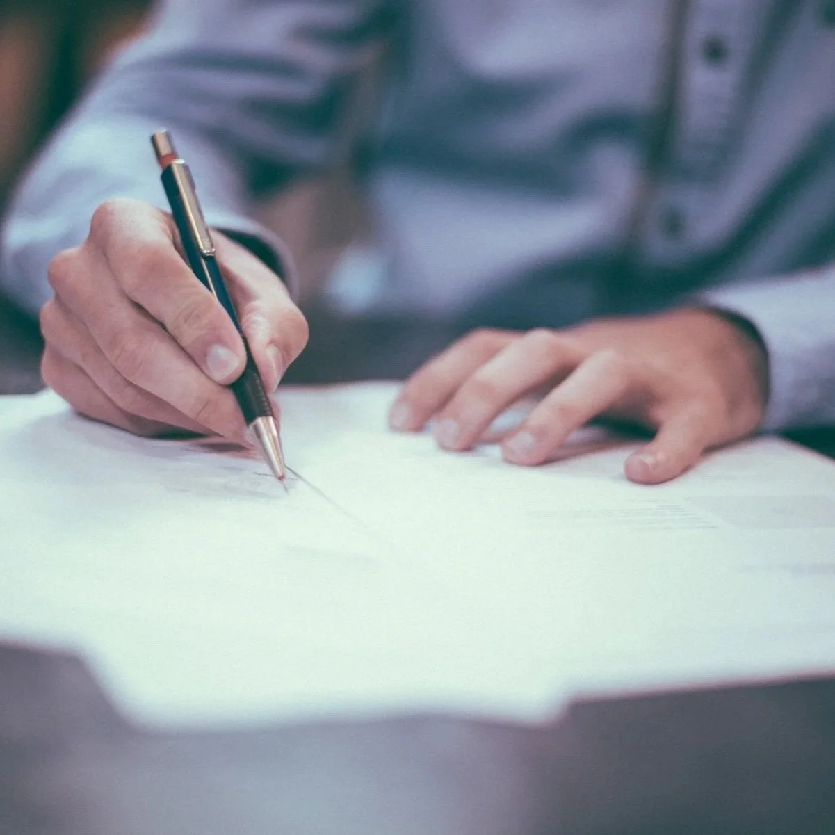 gentleman doing paperwork at desk