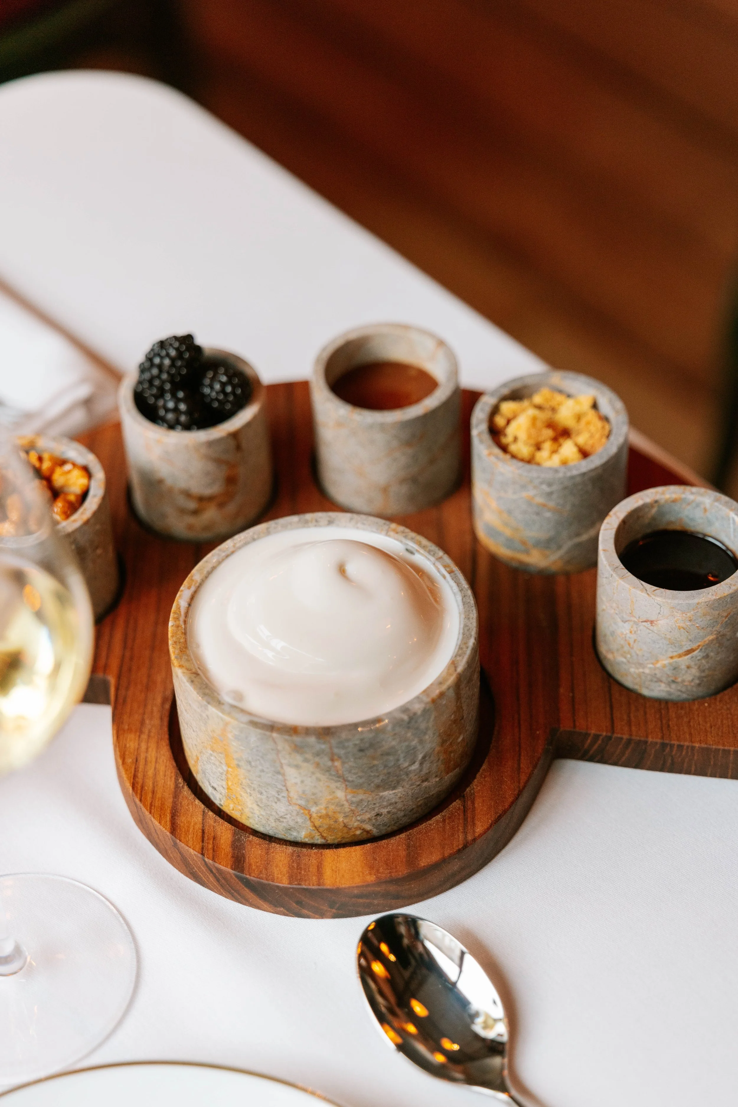 A rustic table with canapé platters on a wooden board.