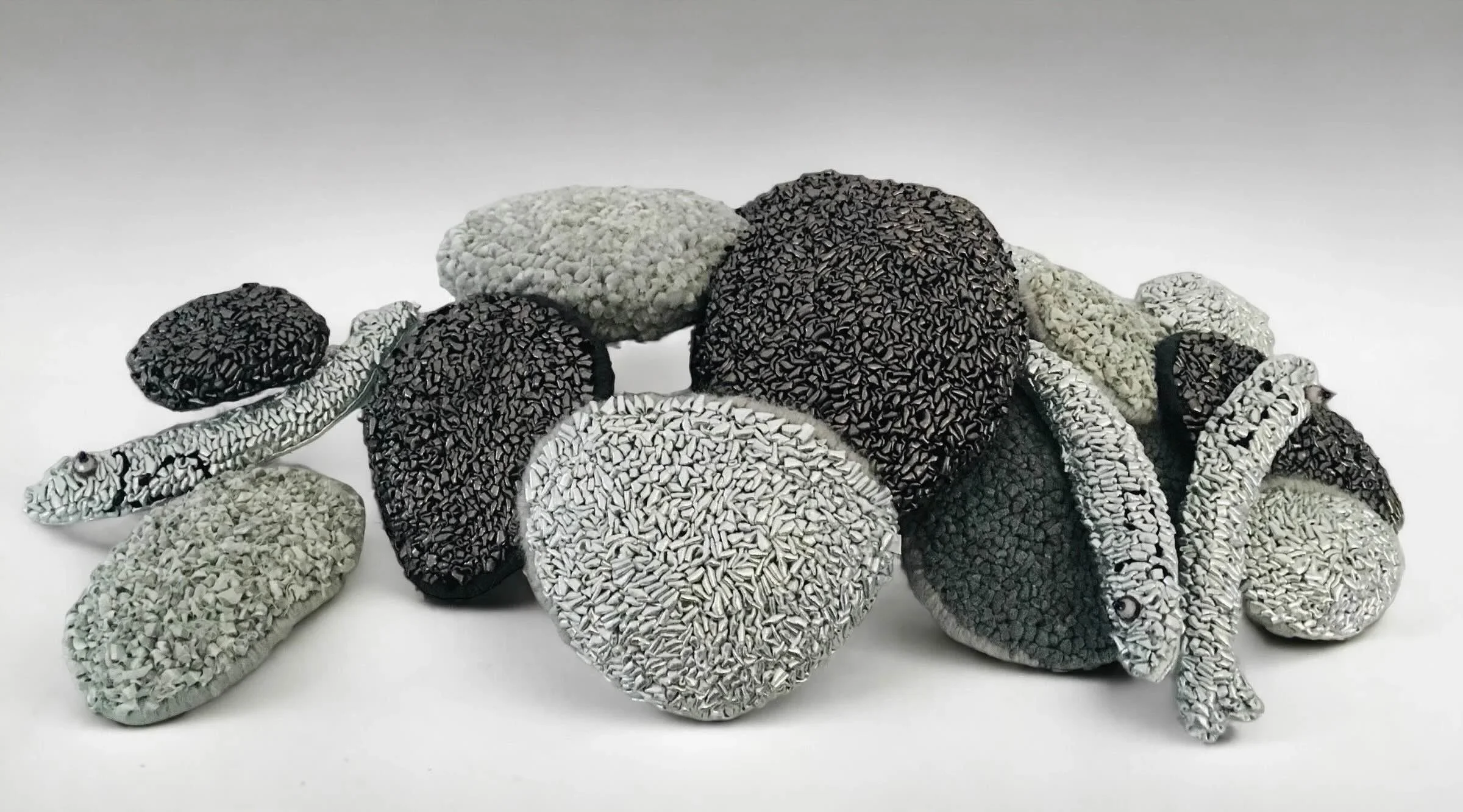 Beached, 24” W x 6” H x 6.8” D, Repurposed and metallic textiles, yarn, bead $550. (w\o kinetic feature)