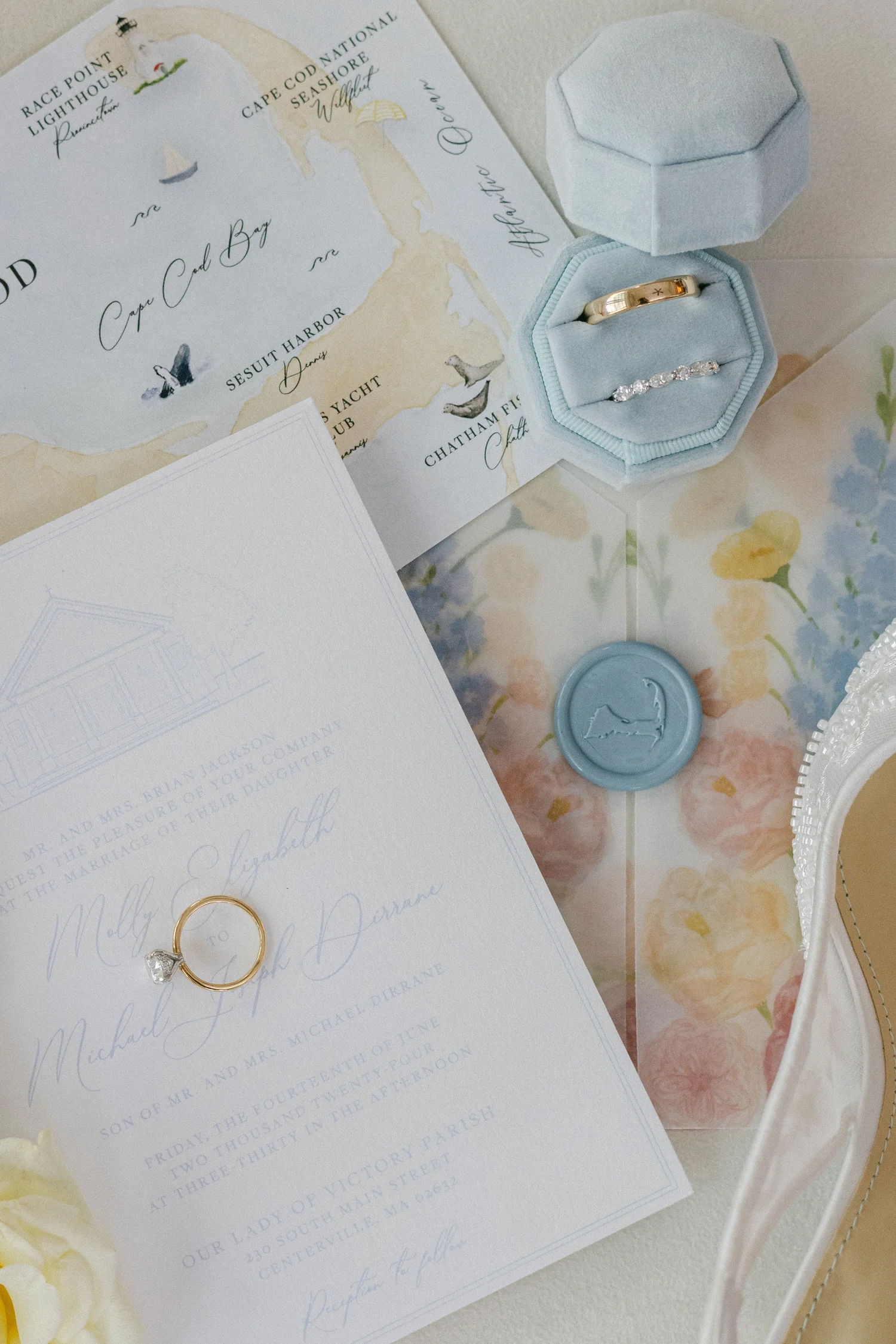 Finished invitation collection with original artwork, a floral liner and blue wax seal