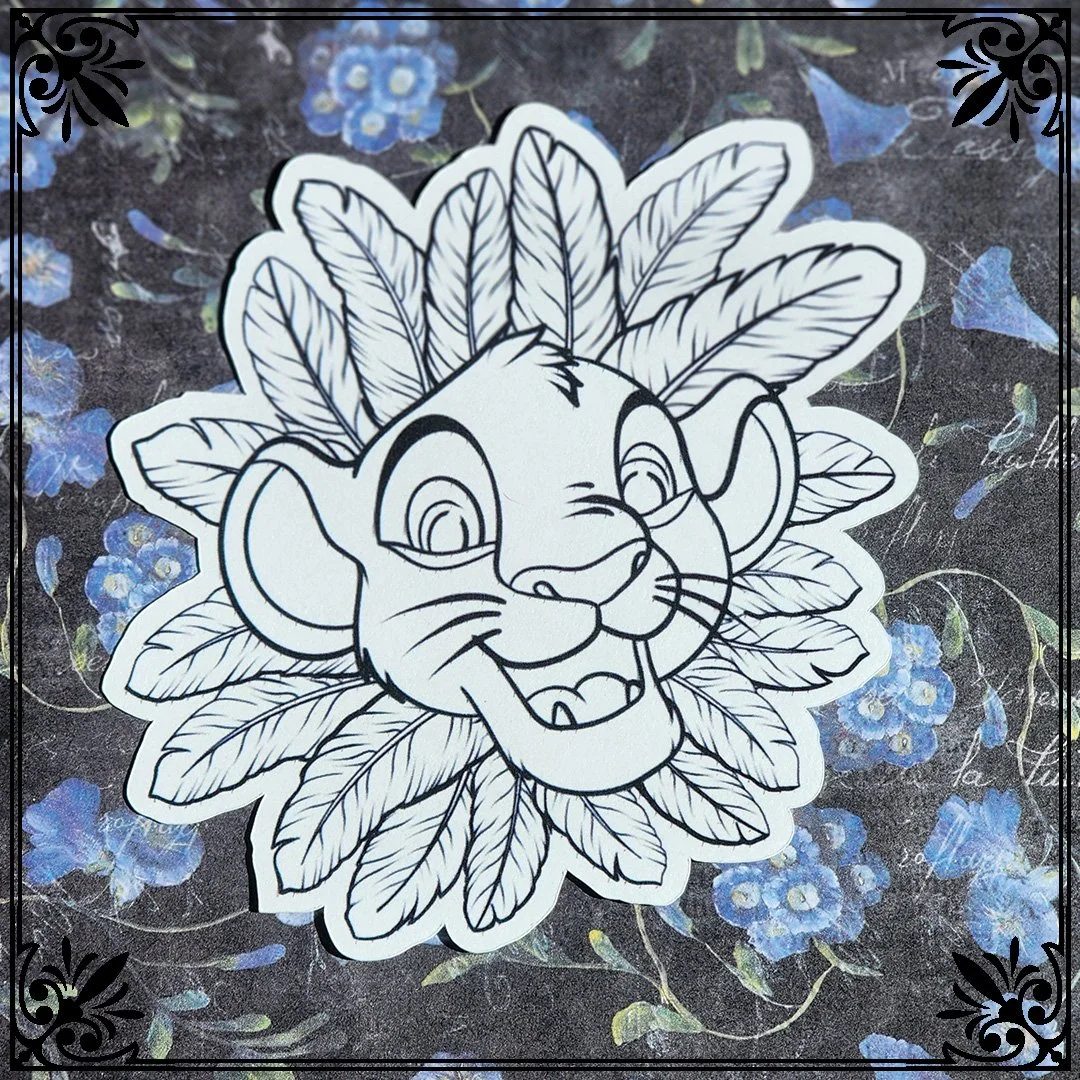 Black and white line drawing of a cartoon lion's face with a mane made of leaves, superimposed on a background of blue flowers and green leaves, with decorative black corner accents.