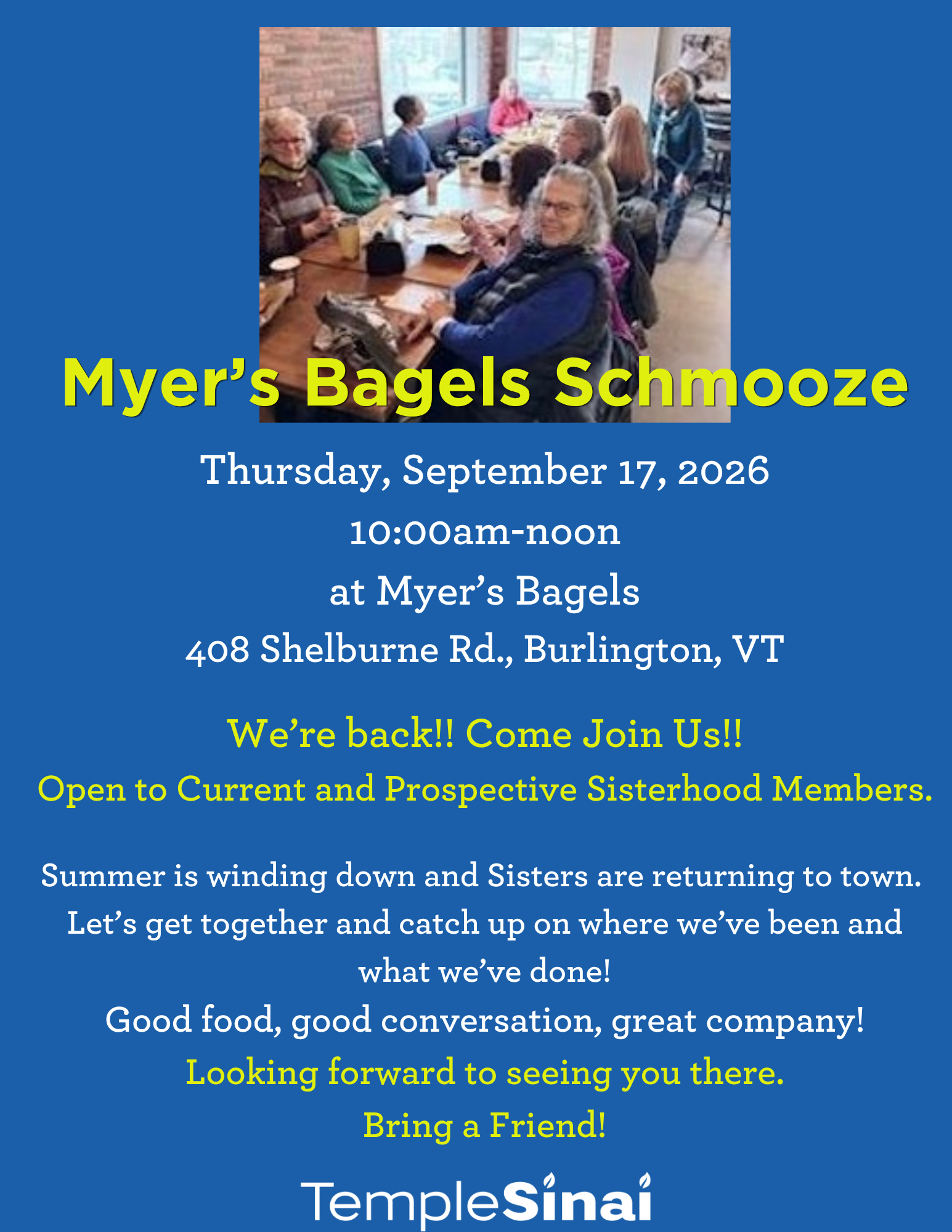 Group of women sitting around along table enjoying bagels and beverages chatting with each other.