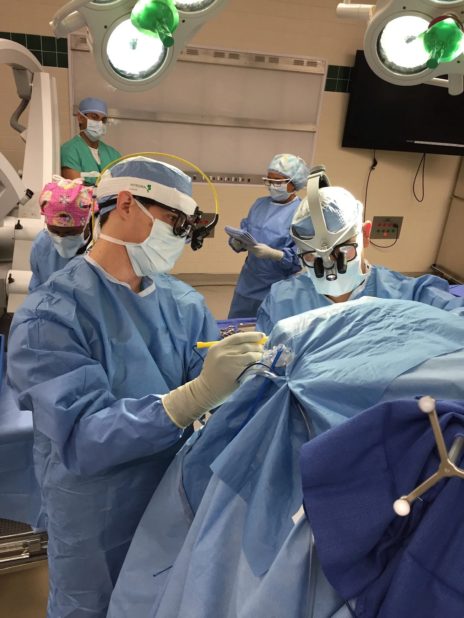 Dr. Joshua Ryan in an operating room performing surgery.