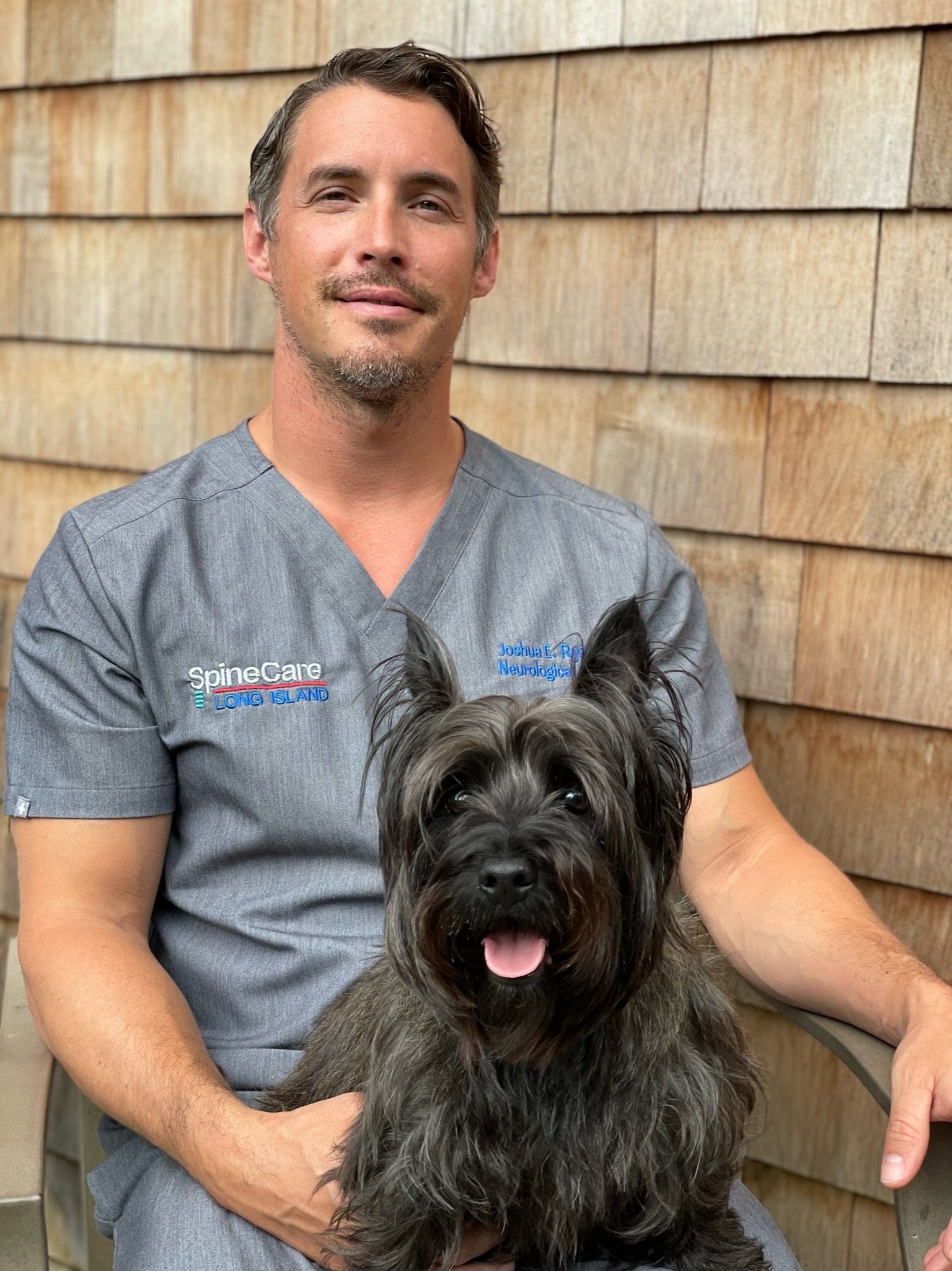 Dr. Joshua Ryan with his little cairn terrier Lucy (like Toto from The Wizard of Oz). 