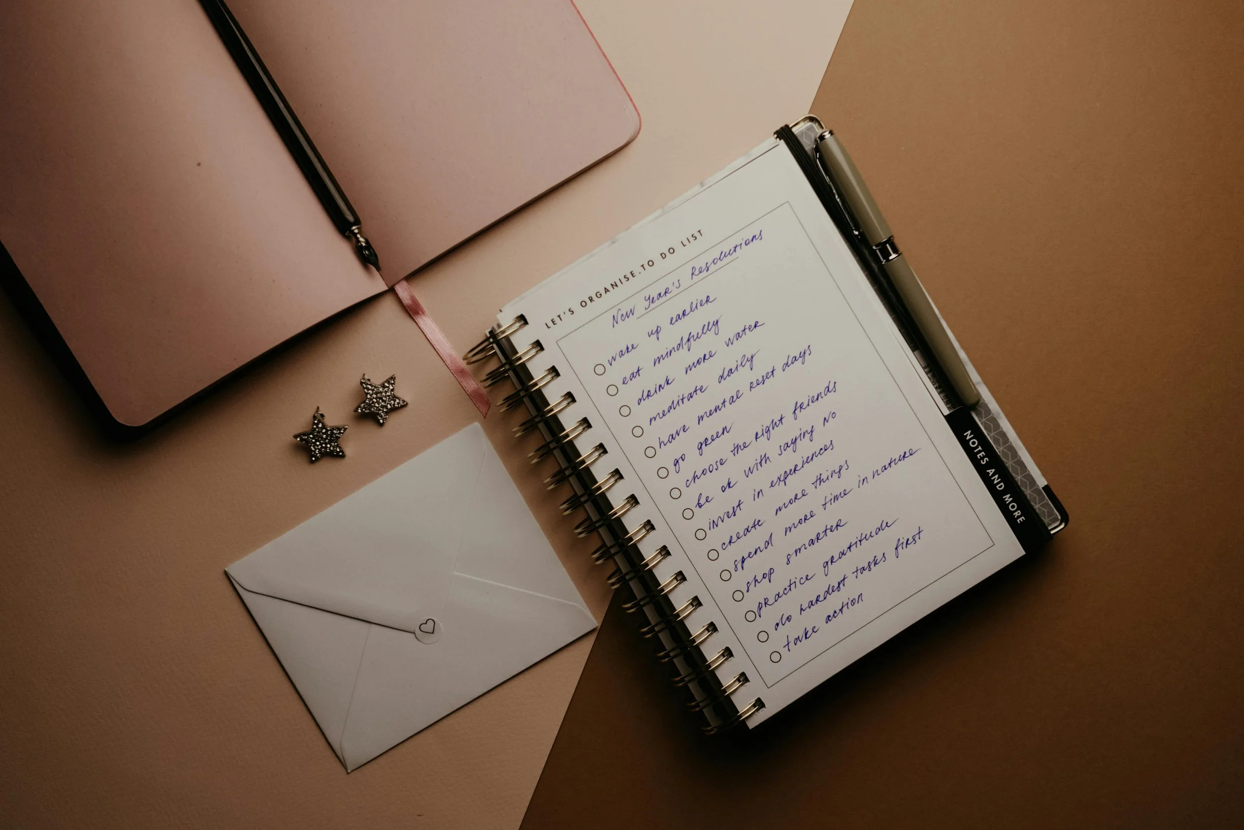 An open journal with a list of New Year's resolutions.
