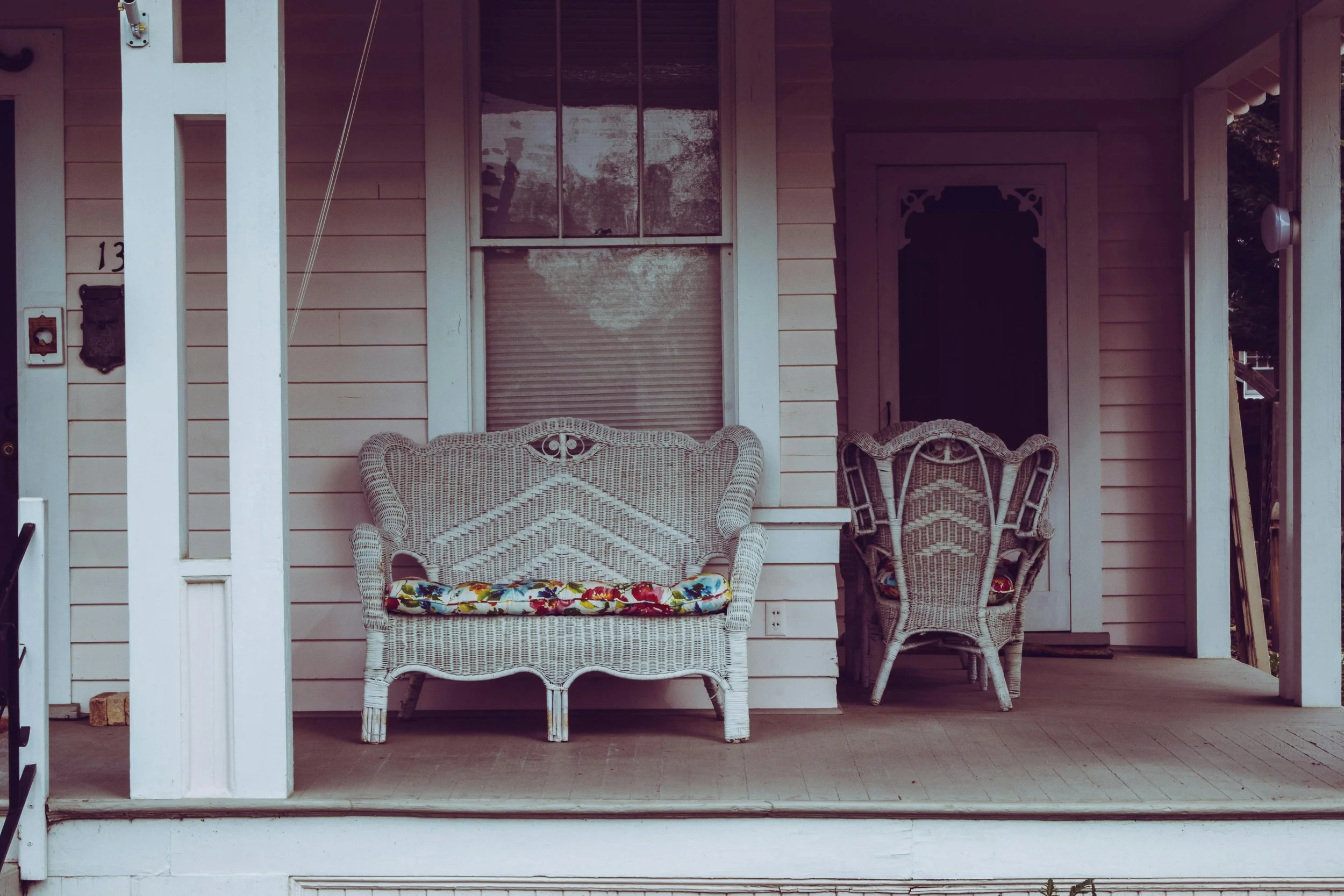 A beautiful front porch with chairs for sitting and enjoying the day.