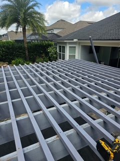 Wood pergola structure built over an outdoor spa, providing partial shade and architectural detail in a residential backyard.