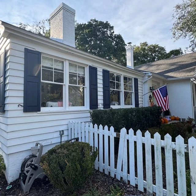Custom-fit black wood shutters mounted beside double-hung windows on a historic Avondale Jacksonville residence.
