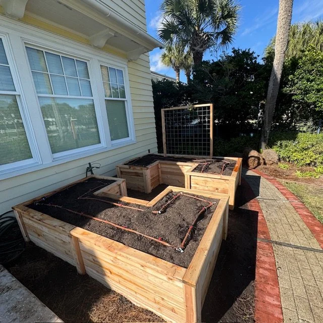 “Custom cedar raised garden beds with drip irrigation installed at Ponte Vedra Spa & Club, designed for organic gardening in a coastal Florida landscape.”