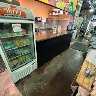 Interior view of a handcrafted coffee bar at Grassroots Natural Food Store in Five Points, Jacksonville, Florida, designed for efficient service and retail flow.

Image 3: