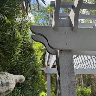 Image 2 (decorative bracket close-up):
Close-up of decorative wood pergola bracket detail on a spa pergola, showcasing custom carpentry and exterior finish.
