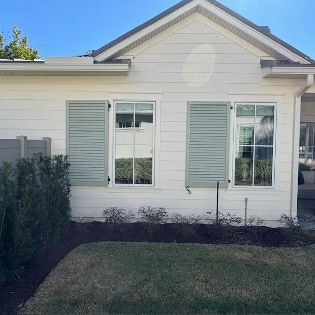Custom louvered exterior shutters installed on a riverfront home in Palm Valley, Ponte Vedra Beach, Florida, designed for coastal durability and light control.