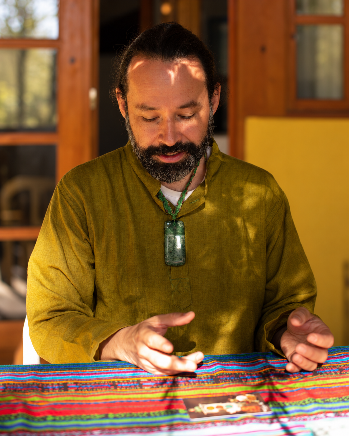 Andrés seated at a table, preparing a Nawal Reading.