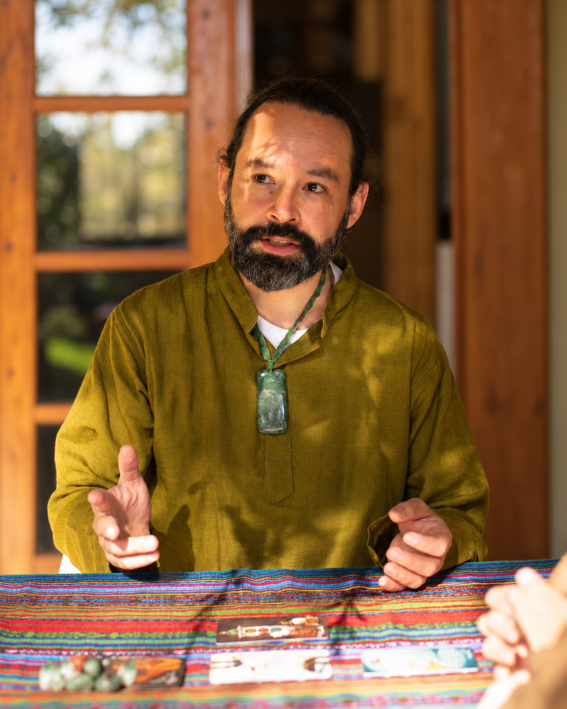 Andrés in conversation across a table during a private one-to-one encounter.