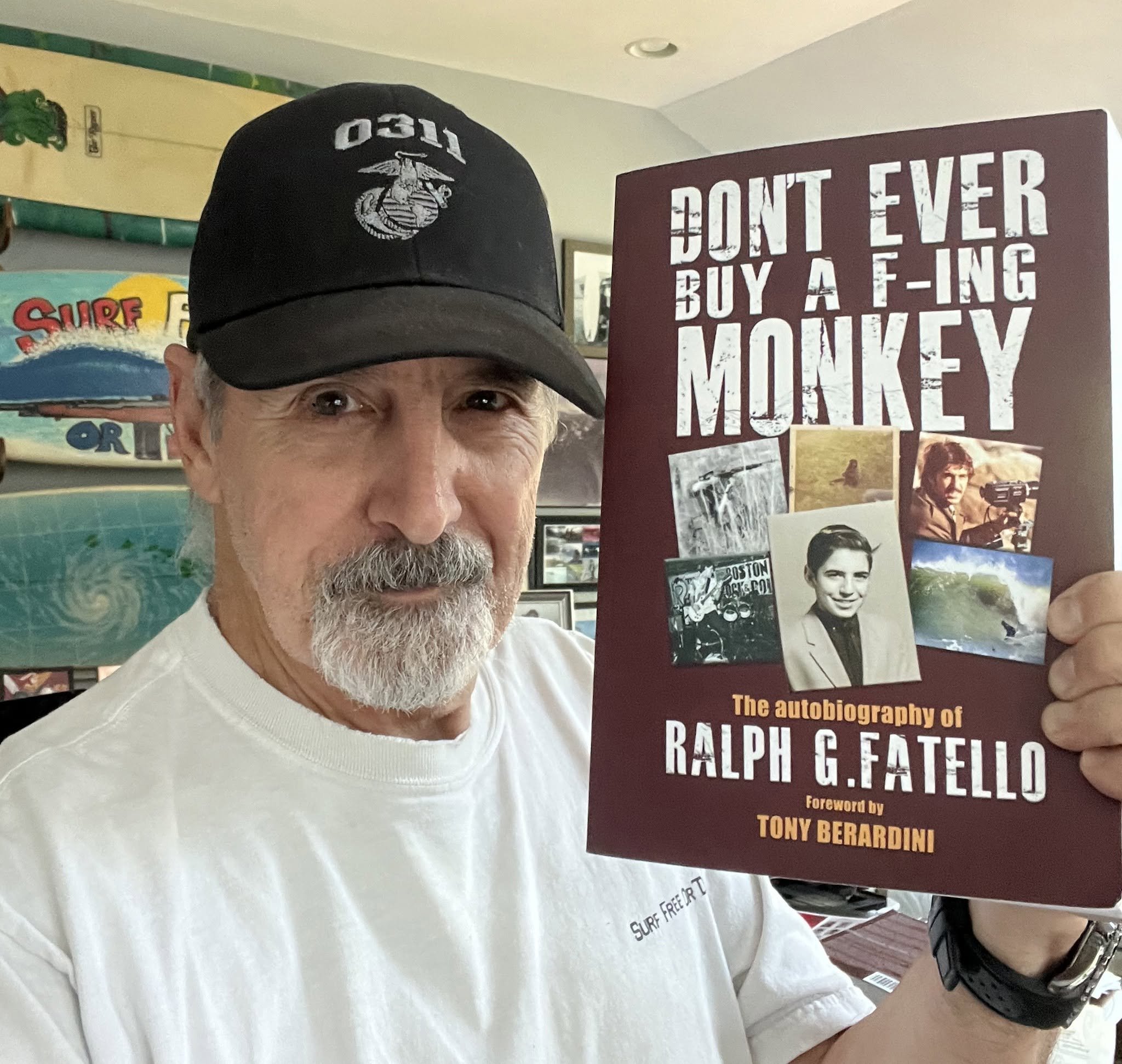 Ralph Fatello, 2026 Grand Marshal, holding his autobiography