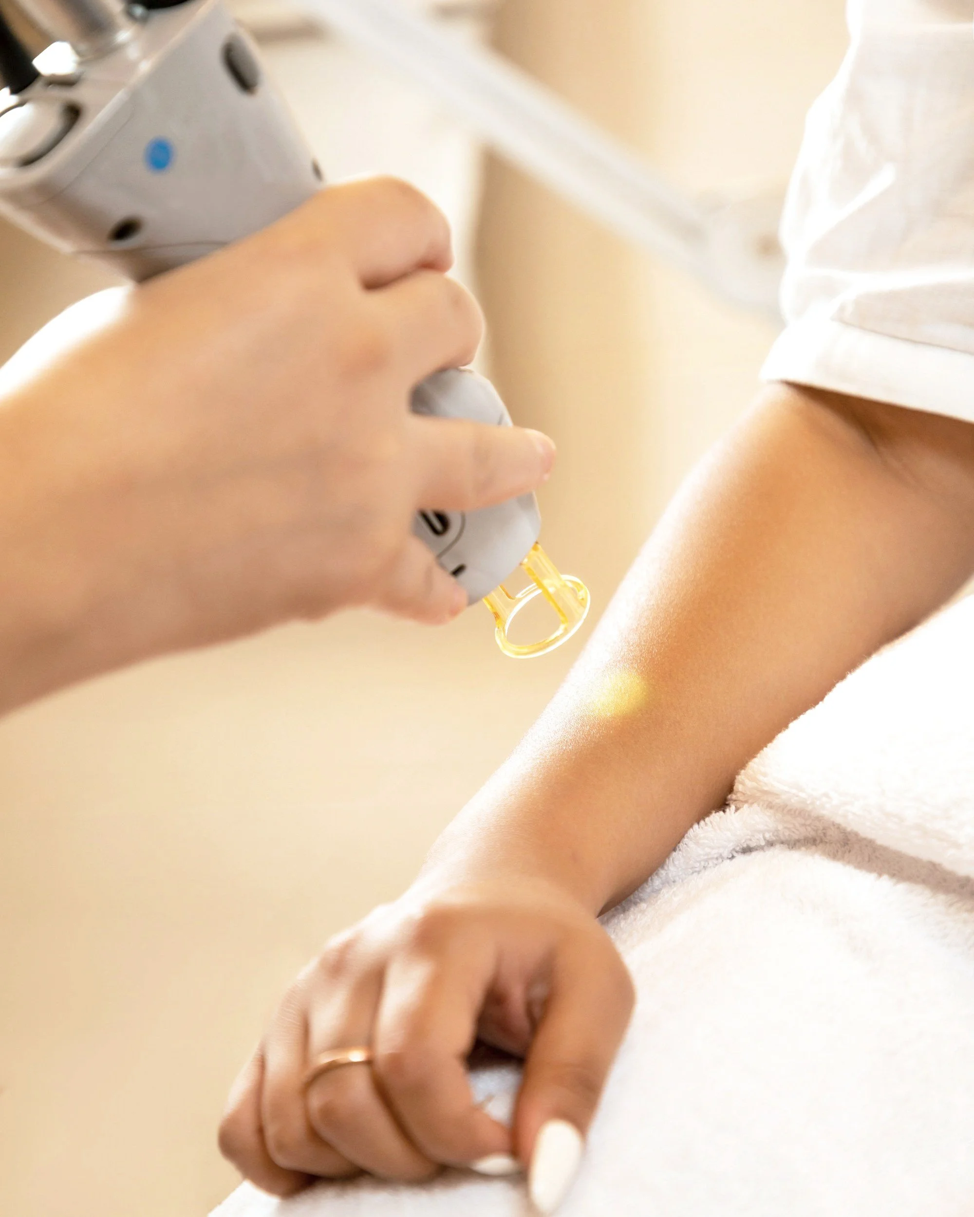 Healthcare professional administering an injection into a patient's arm.